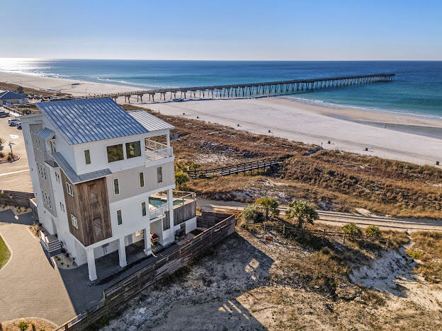 ANOTHER MASSIVE PRICE REDUCTION!!!! HIGHLY MOTIVATED SELLER! Find coastal luxury with this magnificent 6 bedroom/6 bathroom 2 half bath beachfront retreat, designed to accommodate up to 16 guests in unparalleled comfort. Nestled against the shoreline, this haven offers an array of exceptional amenities that promise an unforgettable escape. Immerse yourself in the allure of outdoor leisure with a dedicated lawn game area featuring foot pool, cornhole, and mini golf. A symphony of style awaits within, where each corner is adorned with tasteful décor. A fully equipped kitchen and convenient kitchenette cater to your culinary desires, ensuring every meal is a delight. Equipped with an indoor elevator this home has everything you need for that luxurious beach lifestyle. Buyer and Buyers Agent to verify all information for accuracy.