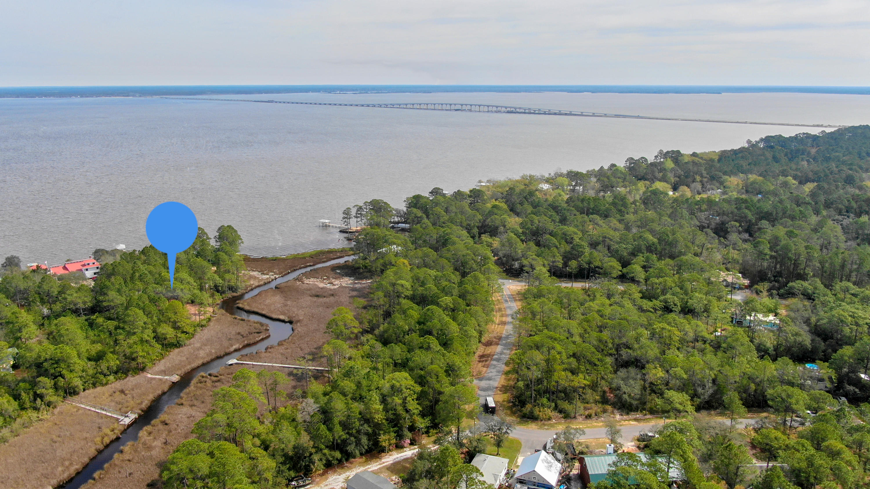 Great location to build your dream home with unobstructed bay views and sits next to county park land that will never be built on. Lot is surrounded by lush natural landscape which provide all the quiet and privacy that is hard to come by. Property is nestled north of Chat Holley Road, far enough away from the hustle and bustle of Highway 98. Lot features 203 feet of stream/creek waterway that is fed direclty from the Choctawhatchee Bay. Perfect backdrop for paddle boarding, kayaking and small water craft.
Although, the property is secluded, you will still be within minutes of the Emerald Coast's best beaches, local favorite restaurants, shopping and attractions. You could say this lot is surrounded fun!