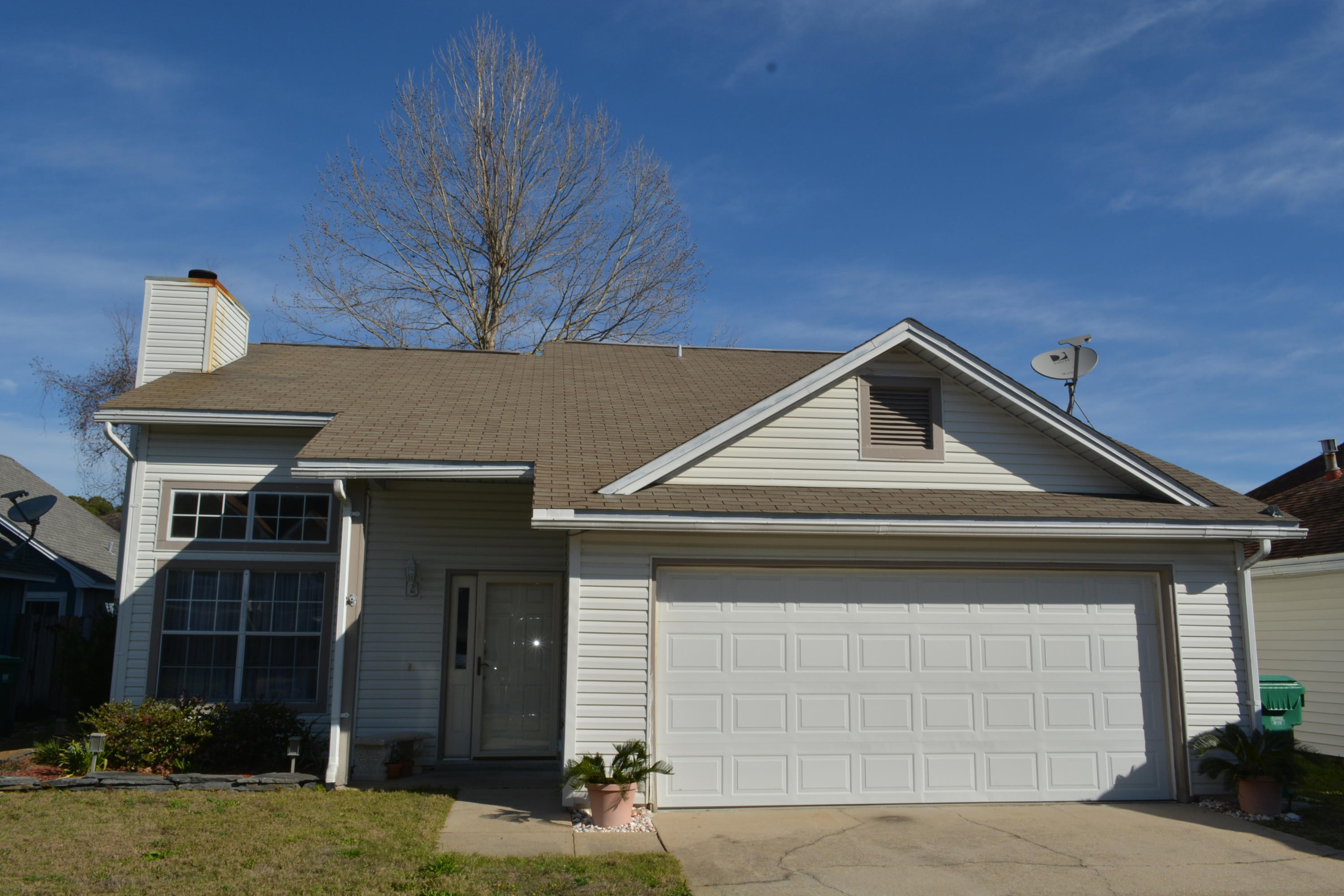 Great Location - 1/2 mile to Hurlburt! Large Living area with vaulted ceilings and plenty of windows to let the natural light in! Living Room also has a Woodburning Fireplace for cozy fires on cool nights. Open Living/dining combo with wood laminate flooring. Kitchen & dining seperated by breakfast bar. Master Bedroom & bath are downstairs. Master bath has dual vanity and Garden tub. Two additional bedrooms and full bath are upstairs. French doors in Dining room lead to Screened in patio and out to the privacy fenced back yard. Screened Room has rubber flooring and there is also an dditional large open patio! Tile in Kitchen, Foyer and bathroom. Two car garage with pull down stairs for extra storage! Lawn Pump and Sprinkler system in place too! Come see this home today!
