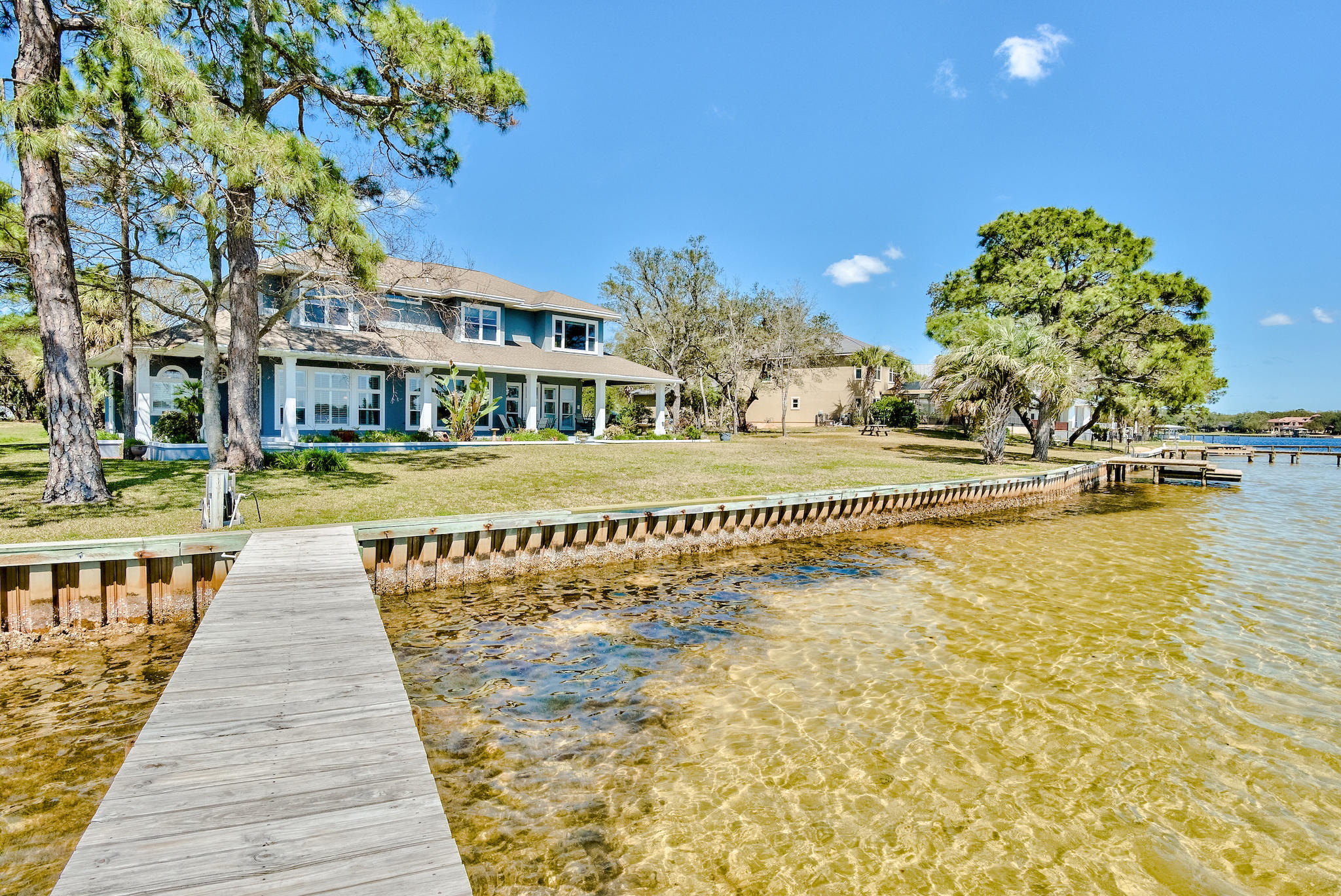 Welcome to 15 Paradise Point, Shalimar Florida. This immaculate one-owner custom-built home is optimally positioned on a half-acre lot and features panoramic views of Poquito and Gariners Bayou. This amazing 4400+ sq ft home includes 4 bedrooms, 3.5 bathrooms, an office, a bonus room, and a 2 car garage with a workshop. The home displays beautiful bayou views in the master bedroom. front room, living room, kitchen, a second bedroom, and the bonus room. Built with entertaining in mind. The front room includes a wine fridge and wet bar. The kitchen includes maple cabinets, granite countertops, stainless appliances, double ovens, and a gas range stove. The kitchen features an open concept, perfect for interacting with family and friends in the living area while making their favorite meals. On the other side of the kitchen, you will find a spacious laundry room, half bath, and access to the 2 car garage with a workshop.  The master suite, ideally located on the opposite end of the home showcases amazing water views, a powder room, a walk-in closet, and access to the back porch. The second floor features an ample and flexible bonus room with more amazing views. There are also three bedrooms and two bathrooms on the second story. All of the bedrooms feature oversized closets and plenty of space. 
Outside you will see a well-manicured lawn, plenty of beautiful plants, and a private dock with a boat lift.

The home has a transferable lifetime warranty on windows and a transferable warranty on the exterior paint.

Check out the 3D tour!

Schedule your showing today.



***Buyer to verify all data and dimensions****
