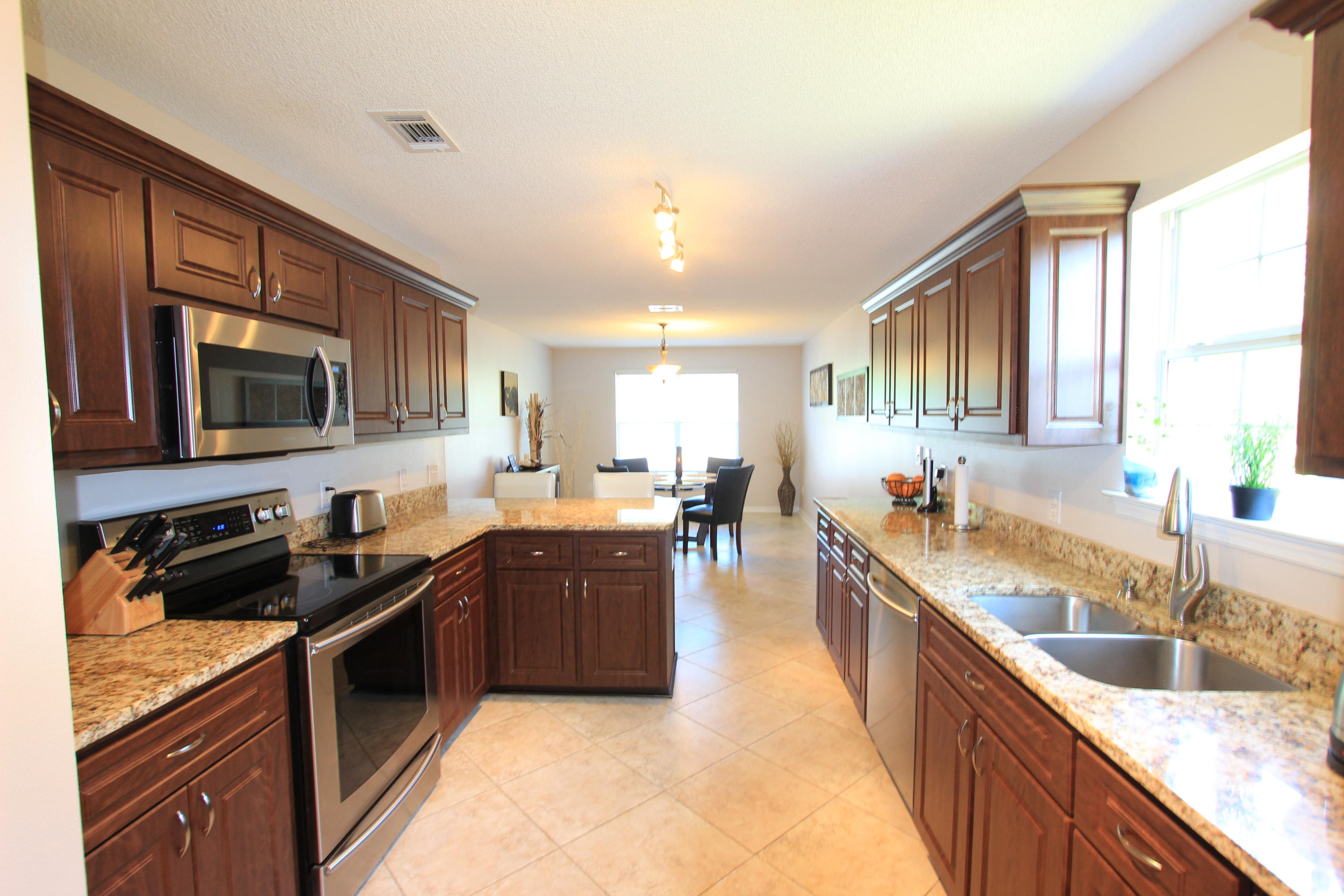 This is an excellent opportunity to purchase a newer 4 bedroom home in Gulf Breeze. The floor plan includes a spacious eat-in kitchen, office/den, family room, 2-1/2 baths, 4 bedrooms, upstairs playroom, and walk-in closets in three of the bedrooms. Interior features include 18'' diagonally laid ceramic tile floors and upgraded carpet. Beautifully modernized, all new kitchen with new mocha cabinet doors and drawers, granite counter top, and stainless steel appliances. Bathrooms also have new cabinets, granite in guest bath and marble in master bath. The whole interior was recently painted in warm colors, with some tasteful accent walls. The exterior offers a combination of brick and vinyl siding. The yard was recently landscaped with palm trees, banana trees, a tangerine tree and many plan