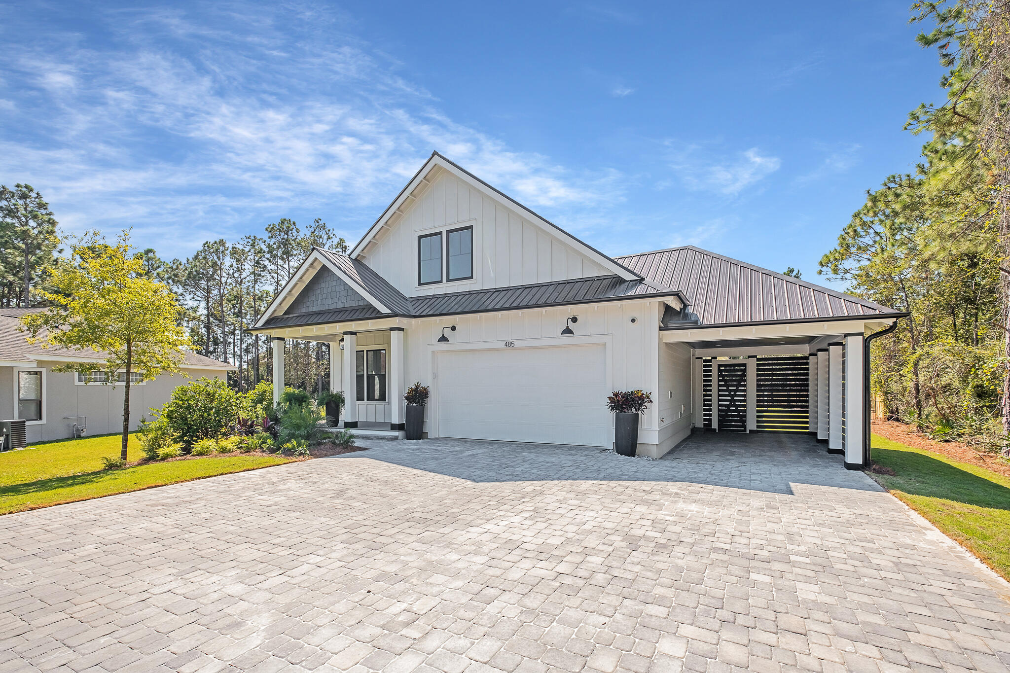 Beautifully designed and primely located on Golf Club Drive, this exceptional new construction retreat in Dune Allen Beach masterfully built by renowned Cogent builders offers idealistic beachside living. This coastal home yields a well appointed two-story design with spacious, ground floor living and ample space for entertaining. The main level is characterized by an expansive covered front porch, open living area - complete with a chef's kitchen, walk-in pantry and dining area, all adjacent to the pristine outdoor living. The primary suite offers a spa-like bathroom and direct access to the rear lanai. The ground floor has two additional bedrooms, along with a laundry room and attached two-car garage.