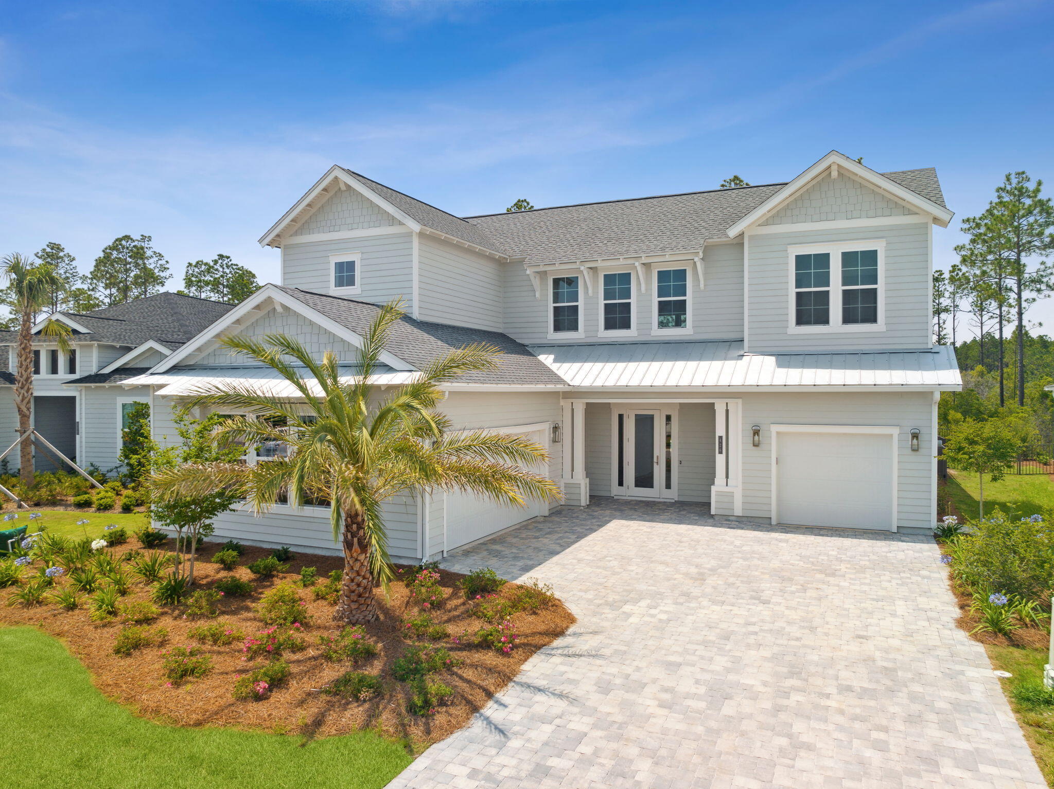 An entertainer's dream awaits, tucked about a quiet cul-de-sac buffering peaceful nature preserve, where your paradise can be found right here in Watersound! This new 5 bedroom, 4 bath home is an absolute stunner, equipped with an incredible pool, spa, and 3 car garage! From the moment you walk through the front door, you're met with a striking 22 foot high canopy anchored by a floor to ceiling fireplace, making the perfect focal point, drawing the eye up to the custom coffered ceiling setting the tone for this impressive residence! These craftsman details are echoed throughout the home, and create a seamless flow with this builder's top-tier design, customized to meet the needs of a discerning family, and would make for an incredible secondary home fit for the perfect Florida lifestyle! 5 stage accordion glass doors flank the great room and allow for a seamless transition merging the inside and out! The fabulous extended covered lanai features 612 ft.² of covered outdoor living space with a wonderful summer kitchen! The entire home is wired with a superior state-of-the-art audio package and surround sound system so you'll never miss a play during the next big game! Relax in your tranquil 17' x 33' saltwater pool, crowned by a 6' x 8' raised spa with 3 waterfall spillovers, multiple fountains, a tanning shelf, umbrella holder, and 16' corner bench! Take day to night with your 7' x 3' fire feature box and custom pool lighting for the perfect ambiance! You'll fall in love with the incredible chef's kitchen featuring a bold waterfall island with 3cm quartz, and GE Café Series appliances, such as the French door refrigerator, gas cooktop with pot filler and beautiful wall mounted chimney hood with matching quartz backsplash, and a lovely dining area. Cabinetry connects to pantry area and then to laundry complete with custom dog wash station for your furry friend! The master bedroom consists of an entire wing of the home with a terrific ensuite featuring a freestanding tub, optimized glass shower, dual vanity, and huge master bedroom with custom closet already on order! (Ask for design plan!) An additional bedroom on the main level with a full bath makes for a perfect guest bedroom or office space. Travel to the upper floor and discover a whole additional upper suite, centered by a great loft landing perfect for a relaxed second living space. Two additional bedrooms share a full bath, each with custom wooden shelving in closets! Life in NatureWalk at Watersound Origins is perfect for the modern lifestyle with a master planned community adorned with bike trails, manicured landscapes, golf, recreation, multiple pools and more! Make this community your home today and experience this exceptional beach community!