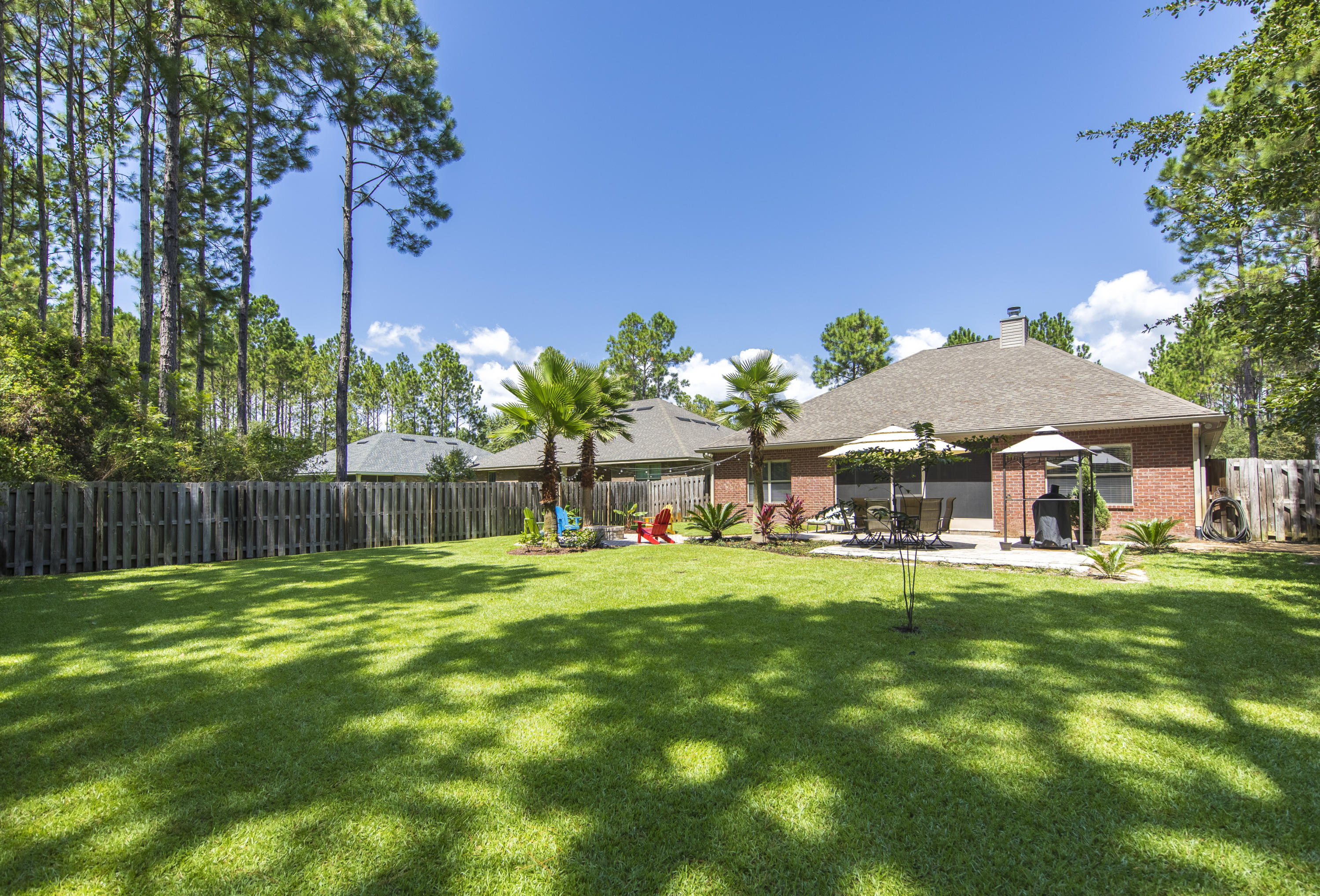What a great place to call ''HOME''!! Located in the Symphony subdivision of Hammock Bay, this home sits on a beautiful lot next to the culdesac, on a very quiet street, and has one of the prettiest yards around! This home has 3 bedrooms and 2 baths, a covered and screened-in rear lanai, and a beautiful fenced-in backyard with plenty of patio space and a firepit that's perfect for outdoor entertaining! The lot is backed up to a wooded area so you have the privacy of not having anyone behind you. The Master Bedroom is very spacious and has a trey ceiling to give it that extra bit of height and the home has upgraded black stainless steel appliances that are included in the sale of the property. CDD fee has already been paid. Buyer to verify all dimensions and perform their due diligence.