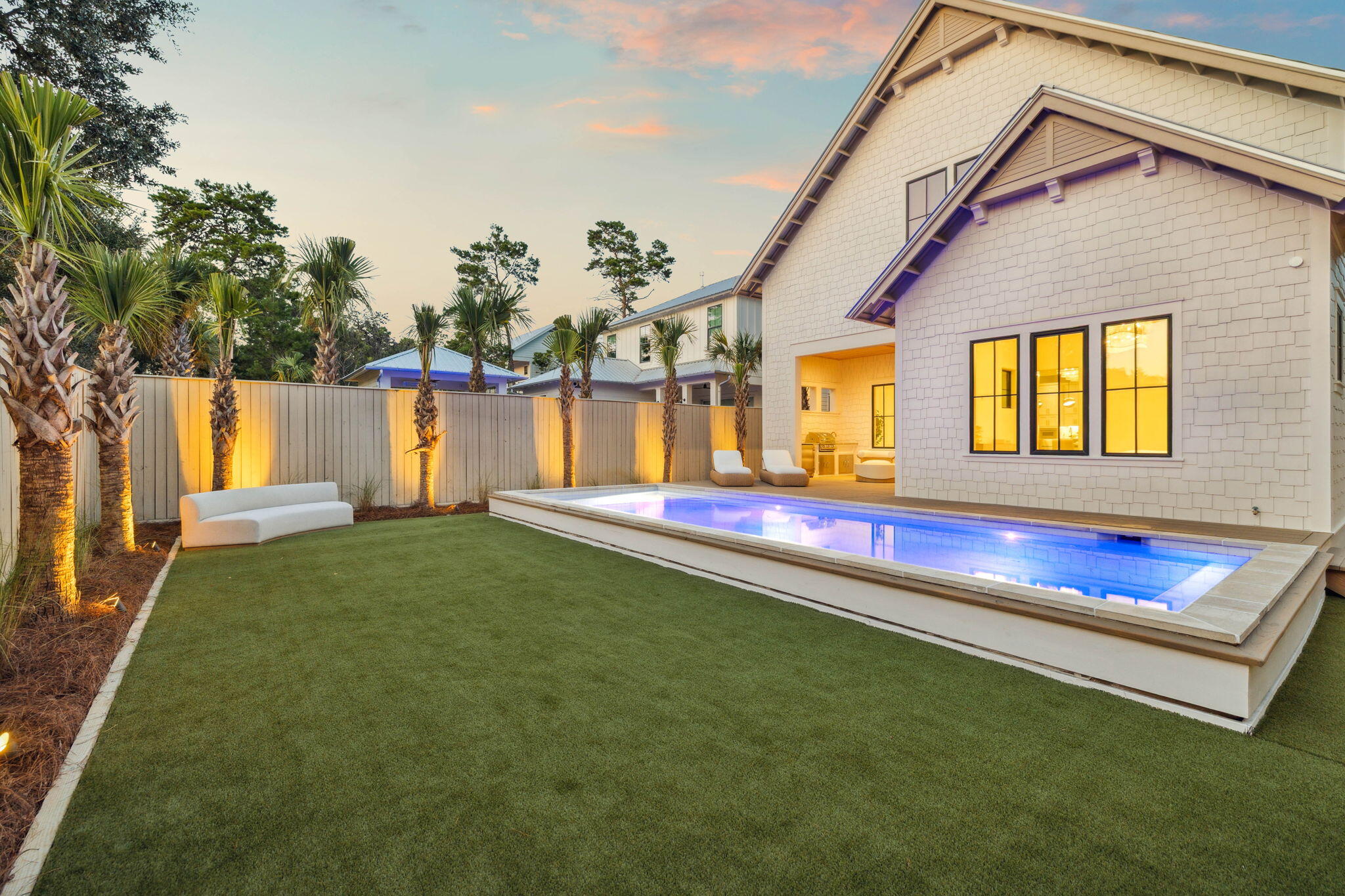 Located in the gated Lakeside Inlet Beach community, this newly built home by Focus Construction blends high-end craftsmanship with coastal elegance. Just minutes from Rosemary and Alys Beach, and steps from Lake Powell, this residence offers the perfect combination of luxury and convenience.

Step inside to soaring 11' ceilings on the first floor accented by rich hardwood floors and cypress wood ceiling details. The vaulted living room creates a light-filled gathering space that flows seamlessly into the gourmet kitchen, complete with Thermador appliances, custom shaker cabinetry, a walk-in pantry, and champagne-accent hardware. The first floor features two bedrooms with ensuite baths, including a stunning primary suite with a vaulted ceiling, spa-style bathroom with a garden tub, frameless glass shower, and custom walk-in closet.

Upstairs, you will find a secondary den and living space, two additional bedrooms with a full bath, and a large mechanical and storage room that provides excellent utility and extra space for organization or seasonal items.

Outdoor living shines here with a heated pool featuring a sun shelf, a backyard recreation area with artificial turf, and an outdoor kitchen with BBQ, sink, and refrigerator surrounded by lush palms and professional landscape lighting. The two-car garage, paver driveway, and gas lanterns complete the home's exterior charm.

Elevated finishes rarely seen in homes at this price point make this property stand out. Thoughtfully designed for full-time living, use as a second home, or as an investment property, this residence offers both flexibility and luxury.

Residents of Lakeside enjoy private lake access, a community pool, and a shared dock on Lake Powell. With the pedestrian underpass offering direct access to 30A, you are just a short walk or bike ride from the Gulf, as well as dining and shopping at 30Avenue including Amigos, Amici's, Cuvee, Idyll Hounds Proper, and Aja Elevated Asian.

This home is a rare opportunity to own a well-crafted and versatile property in one of Inlet Beach's most desirable communities.