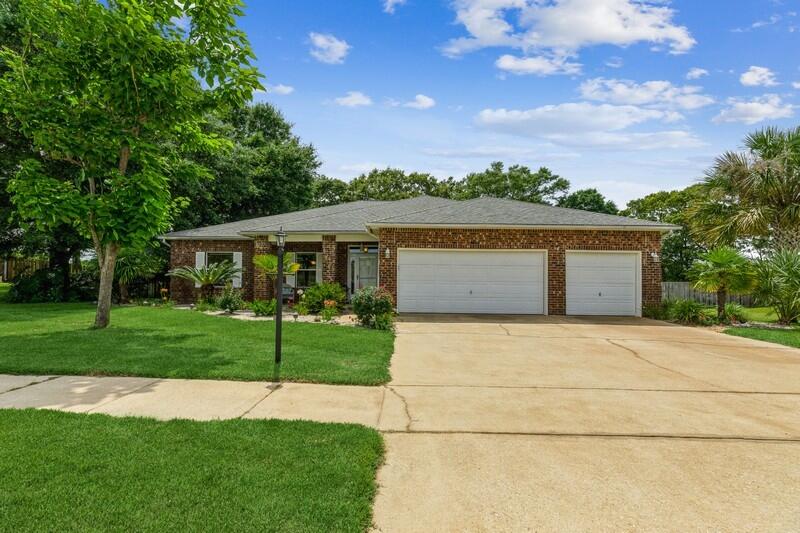 Stunning 4 bedroom 3 bathroom 3 car garage all Brick home on a large 0.51 acre lot in the beautiful community of Carnegie Hills. This updated and meticulously maintained home has an open concept & split floor plan that buyers have come to expect. The home features NEW carpet in all bedrooms and beautifully laid tile on the diagonal with additional custom details throughout all the main areas of the home. New front door w/ glass insert, new storm door and new side door to garage. New refrigerator in 2018 & new stove in 2022. Enjoy the large master suite with spacious closets & beautiful ensuite bathroom with jacuzzi tub, separate shower, double vanities and more... Large 27x18 living room with French doors leading to the tiled screened in porch overlooking the backyard oasis. The kitchen has newer stainless steel appliances, walk-in L-shaped pantry, and breakfast bar large enough to seat four. The home also features a formal dining room for entertaining as well as a dining area just off the kitchen for your day-to-day melas. The 2nd and 3rd bedrooms are generous in size separated connected by a Jack & Jill full bathroom. The 4th bedroom is privately tucked away and has a third full bathroom that accesses the screened in porch. Indoor laundry room is located just off of the 3 car finished garage with side door. The backyard is truly a wonder with number trees, plants and shrubs with multiple outdoor spaces to enjoy. The open patio overlooks the entire yard with beath taking views. Enjoy a cold drink at the Tiki Bar or relax by the stone fire pit area. A lovely herb and vegetable garden is located next to the outbuilding with ramp and two doors and offers plenty of storage. The has has a shadow box privacy fence, Zoysia grass, irrigation system, rain gutters, 3 car garage with finished floor and side door and more... Years of love and attention have been poured into this home. Schedule your showing today because once your enter this home you will never want to leave.