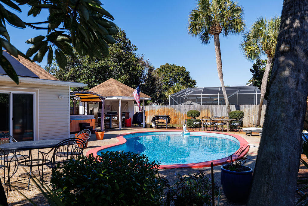 Corner-Lot Home with Pool (and a history) in desirable Indian Bayou!

This beautiful residence is built around a private outdoor oasis, designed for year-round enjoyment. Relax and entertain in style with your own private pool, gazebo, outdoor kitchen and bar, all nestled among lush tropical landscaping. A bright Florida room overlooks the pool and expansive deck—ideal for seamless indoor/outdoor living.

Inside, the home blends comfort and sophistication with extensive custom woodwork, a wet bar, and a spacious layout. The primary suite is a true retreat, featuring his and hers bathrooms, each with separate dressing areas and generous closet space. Plantation shutters grace the dining room and bedrooms, adding timeless elegance. Offering approximately 2,400 square feet of living spaceincluding a sunroomthis home is perfect for those who love to entertain or simply unwind in a peaceful, resort-style setting. And with an average monthly electricity cost of just $30, comfort and efficiency go hand in hand.

Footnote:

A Legendary Hideaway with a Story to Tell...

Built in 1979 for country music's original outlaw, Johnny Paycheck, this one-of-a-kind Destin home is now on the market! Known for his hit "Take This Job and Shove It", Paycheck hosted some of the town's most unforgettable parties right hereand the home still echoes with that spirit of fun and freedom.

Designed for entertaining, the backyard is an adult playground complete with a sparkling pool, hot tub, gazebo, summer kitchen, and wet bareverything you need to live it up like a country legend.

Offered at just $695,000, this piece of musical history could be your next great escape.