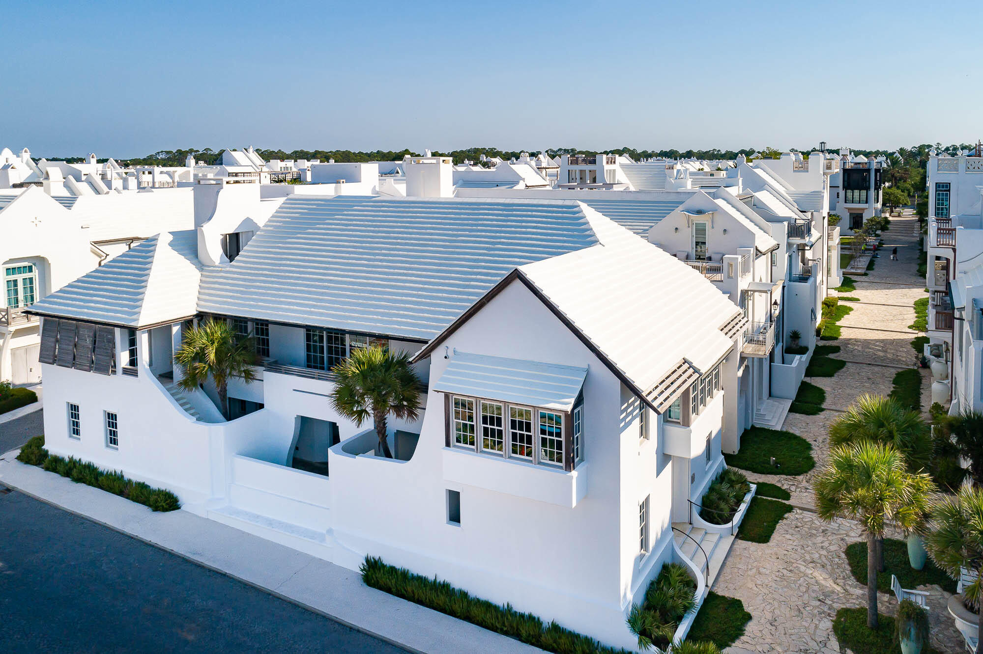 Starr Sanford Design tastefully created an Alys Beach masterpiece found in 6 Shinbone Court.  This premier bookend home is cornered on Sea Garden Street and the Sea Garden Walk Pedestrian Path roughly 75 yards to the Sea Garden beach access.
Gulf of Mexico water views add to the ambiance of this tasteful design by Starr Sanford who created furnishings to compliment the home & the Alys Beach lifestyle.  The main living areas carry whitewashed Oak vaulted ceilings with sliding doors allowing Gulf breezes to flow added with a statement fireplace defining the room.  6 Shinbone Court boasts 4,613 square feet of conditioned living space, which does not include for the designated areas of balconies & terraces.  4 guest bedrooms align the 1st level opening to the courtyard loggia & pool with beverage center and wine cellar.  2nd level access is granted by way of elevator or stair leading to the main living level consisting of the gourmet kitchen & dining, generous living area, media room, office, and the primary bedroom.  Each bedroom hosts en suite bathrooms for privacy.  A summer kitchen loggia is contiguous to the kitchen featuring outdoor dining which leads to the 3rd level roof terrace with a conditioned terrace cabana for entertaining.   This corner condition homesite allows for an abundance of natural light giving way to sight lines of the water and the architecture that has made Alys Beach the destination of destinations.  In addition, the property has a 2-car garage with ice machine and generous storage closets to make full time living an option.  6 Shinbone Court is of very close proximity to the private owners Beach Club.  The Sea Garden Walk Pedestrian Path allows for travel south to the beach and north to Town Center, Zuma, and the like.  This is an incredible purchase opportunity that will not last long.