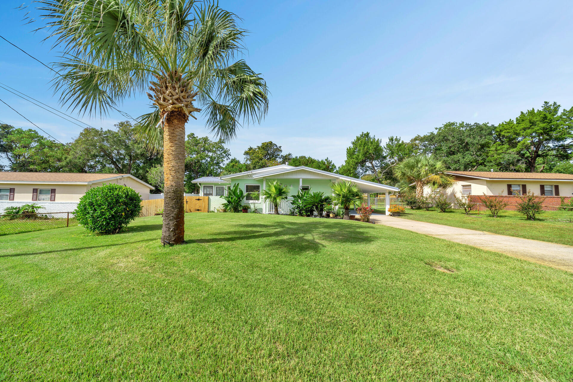 WONDERFUL, PERFECTLY MAINTAINED, RENOVATED HOME W/POOL, CARPORT, 6 YR METAL ROOF, GENERATOR & GAS STOVE IN GREAT NEIGHBORHOOD.  NEWER: Ext paint, high impact windows (except sun rm), bamboo floors & renovated BA + NEW: carpet & fans in the BRs, tile floors in kitchen & laundry & Quartz counters provide a crisp, updated look! A spacious living/dining area & bright sun room w/access to a patio accent the open floor plan & provide space for an add'l BR if desired.  Newly painted cabinets & walls accent the sunny eat-in kitchen w/space for small table & chairs. Relax in your sparkling SALT H2O pool, fenced for privacy & a convenient 1/2 bath w/ exterior shower is just a few steps away!  The large custom ext shed which houses the 1/2 BA & shower could easily be converted to an add'l BR & BA The long driveway & large carport provide plenty of room for an RV, boat or other toys. NO HOA makes this an idea primary home, 2nd beach home or investment property. Other features include NEWER: sewer line, gutters, soffit/gable, well & pump, 2020 AC compressor coils, smart bluetooth thermostat & termite bond thru May, 2024.  A 2020 pool liner, new pool pump & recently changed sand filter provide peace of mind.  The gas stove, gas heater, gas generator & gas water heater provide lower utility bills. Dryer hookup can accommodate either gas or electric dryer. Located in the heart of Fort Walton Beach, this wonderful home is close to schools, shopping, both bases and the beach.