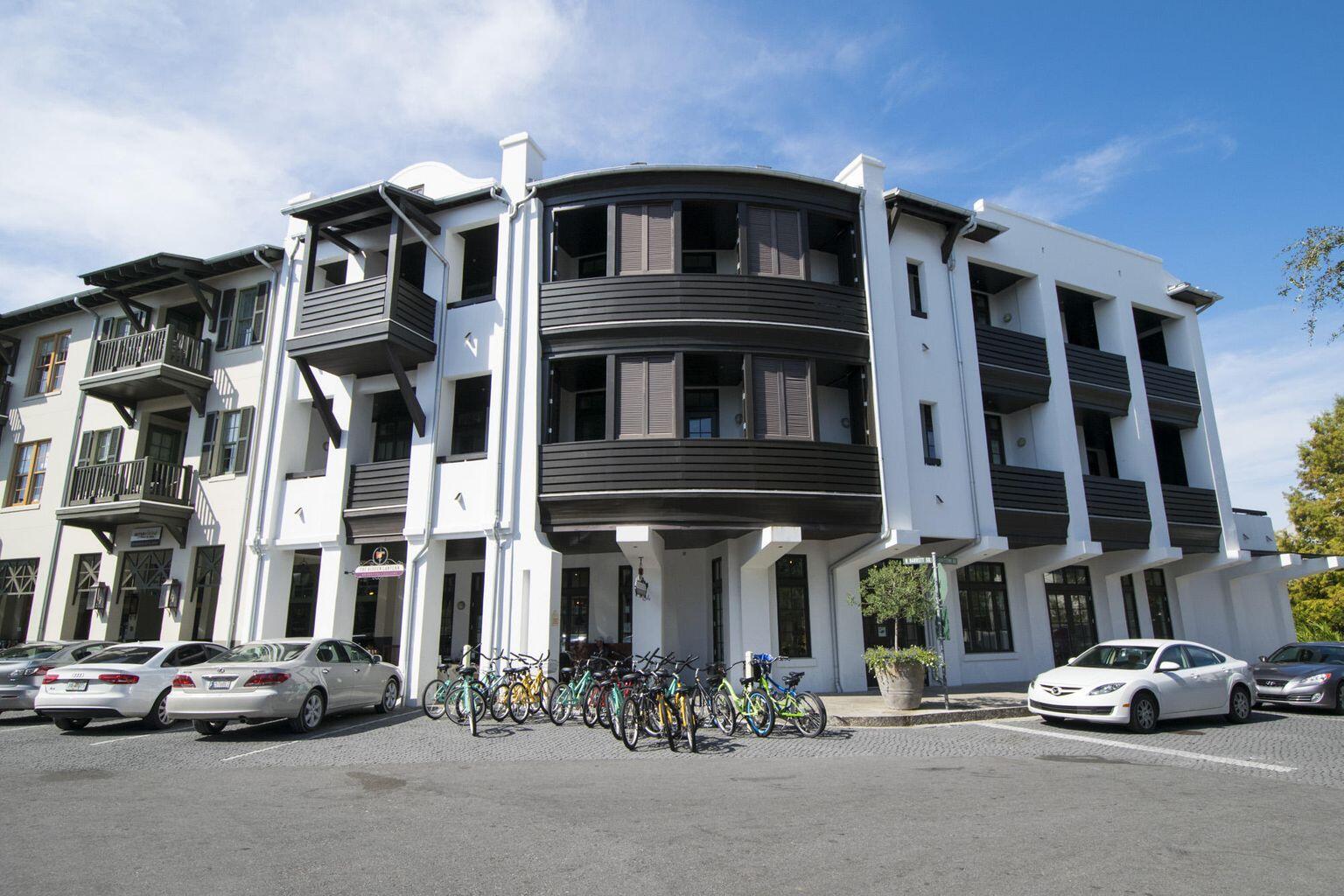A serene sanctuary in the heart of a bustling beach town #6 Tabby Lofts provides the best of both worlds. Enjoy the peaceful, private balcony overlooking a park-like setting while the vibrant town center hums at your feet, or take the elevator to street level and enjoy the activity, shops & restaurants. This lovely, almost 2000sqft loft boasts three bedrooms, plus two bunks and three full baths on two levels. Elegant, dark-stained hardwood floors run throughout. Beautifully decorated, the living room and dining areas span a bank of windows and doors that may be opened to the large balcony to create an open flow between indoors and out.  The entire second floor is home to the master suite and living room.  Is that a peek of the beach from the master balcony?  Yes it is!  Closing mid Dec.