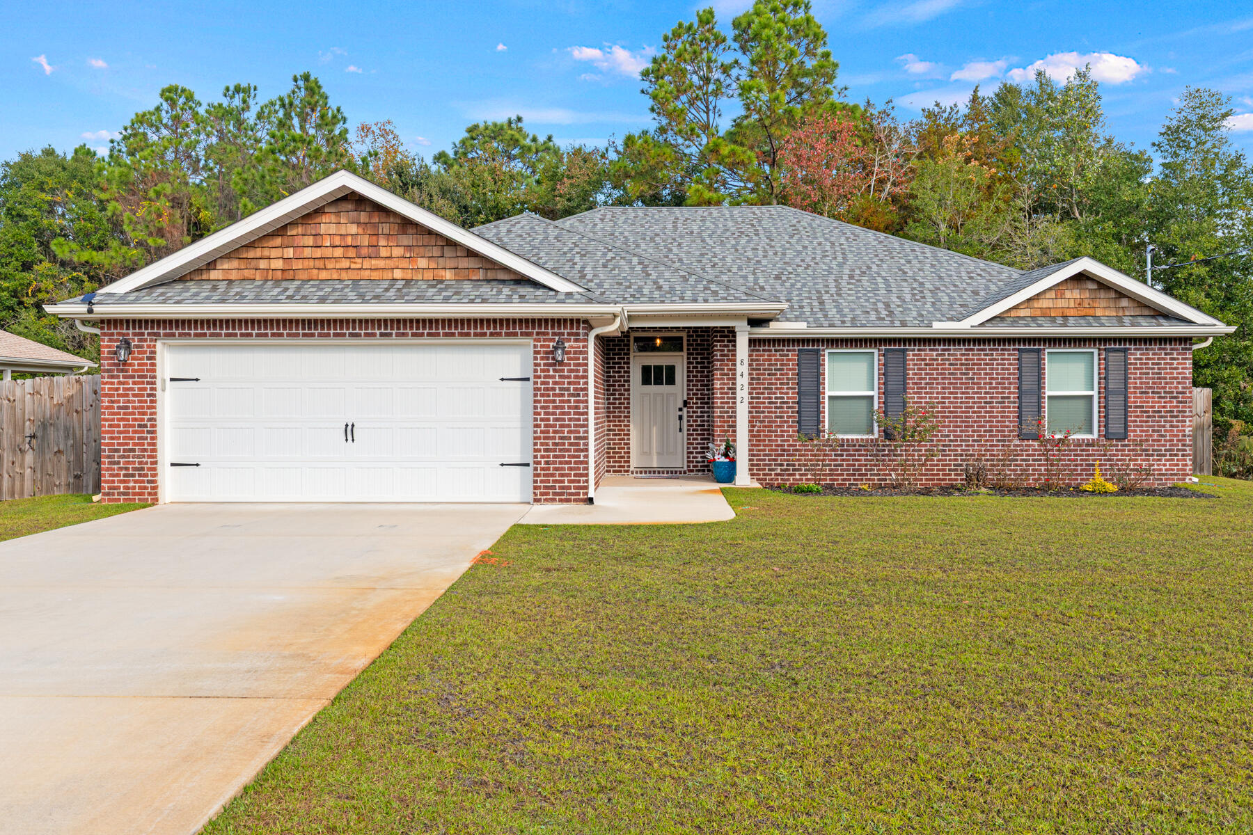 AMAZING, GORGEOUS & PRISTINE 2024 ALL BRICK HOME LOCATED ON CORNER LOT W/PEACEFUL NATURAL BACK YARD. THIS WELL APPOINTED HOME BOASTS SPACE & COMFORT.
Upon entry through a wide foyer, you are greeted into the LIVING ROOM with tall vaulted ceilings, a modern ceiling fan & spacious area. The adjacent very roomy KITCHEN opens to the living room but separated by a large eat up counter bar. The kitchen is adorned w/high-level granite countertops, Beautiful shaker style cabinetry w/lots of storage, quality stainless steel appliances, a window kitchen sink that overlooks the backyard & stylish pendant lighting. The large DINING AREA sits in it's own sunny space. A separate huge MASTER BEDROOM has recessed ceiling w/fan and presents a cozy private oasis. The MASTER BATH has double vanities with high level granite tops, bronze waterfall faucets, a lighted roomy separate walk-in shower and ample walk-in closet for two.
NOTABLE HOME FEATURES: High quality LVP Flooring throughout all room areas w/tile in baths. HVAC w/germicidal UV Light system. Large LAUNDRY ROOM w/tub sink. Double door PANTRY. BEDROOMS are roomy & all have ceiling fans. Soft close cabinet doors/drawers. BATH 2 has high level granite w/tub shower combo & bronze waterfall faucets. French doors to patio have built in blinds. Bull nose corners. Upgraded quality faucets, fixtures & hardware throughout. 2" Blinds throughout. Well pump irrigation system w/digital box. Roomy Covered BACK PATIO. Privacy fenced w/2 wide gates (6' & 5.5'). 
6' wide entry walkway. Quaint backyard has serene natural view. Spray foamed attic ceiling. Hurricane fabric shield protection. Transferable termite warranty bond. Convenient location to beaches, bases, schools & shopping. A MUST SEE HOME!