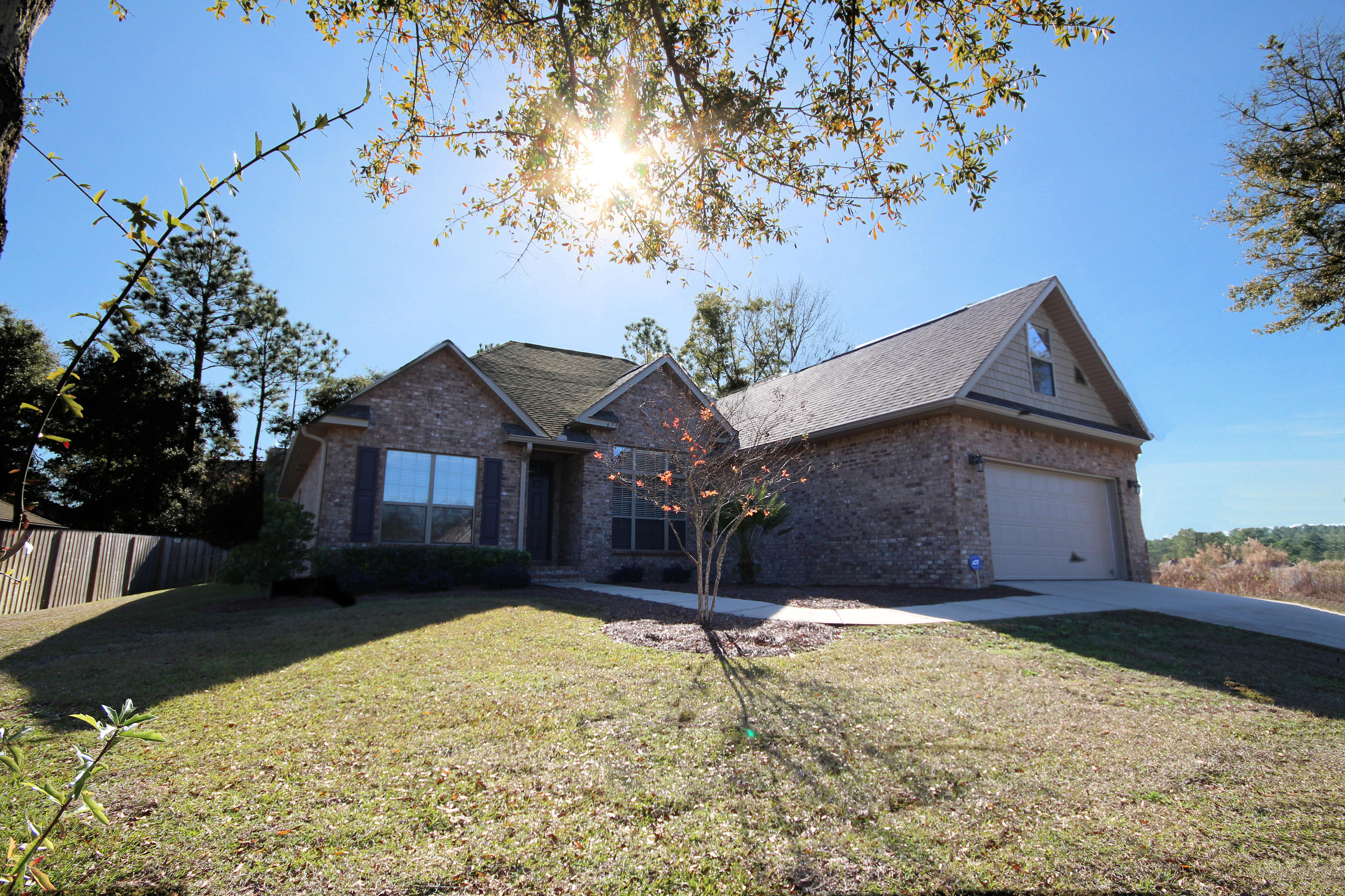 GOLD STAR PROPERTY - means this immaculate home is a TRUE VALUE, ready for you and more** This brick home is for sale South of I10 in Crestview, FL. This property is move in ready and features 4 bedrooms PLUS an office AND a dining room! You will appreciate the mostly level, fenced backyard, screened in porch, alarm system, granite counters, breakfast bar, stainless appliances, kitchen island, pantry, split bedroom floor plan, over 2,500 sq feet and so much more! The master bedroom features tray ceilings, double vanities and a huge closet. This home has been so well taken care of and barely lived in that it feels brand new! **Gold Star Benefits: Sparkling Condition and Curb Appeal, Priced Right & Move In Ready, FREE AHS Home Warranty, Lender fees waived w/ preferred lenders* Call now!