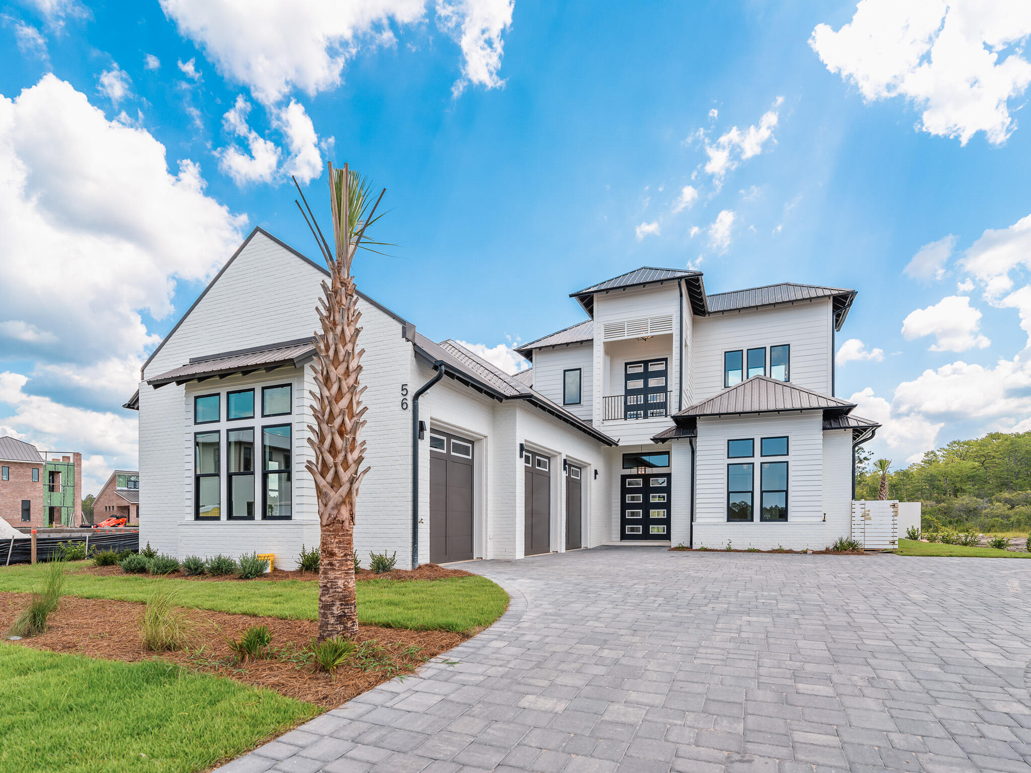 Designed by renowned architect John Williams, this elegant new construction—nestled behind the private gates of Camp Creek—showcases impeccable craftsmanship paired with refined coastal charm throughout. The kitchen is a chef's dream, featuring custom-milled cabinetry, an expansive island, quartz countertops, and a luxury appliance package complete with a gas range. Flowing seamlessly from the kitchen, the spacious living and dining areas provide direct access to a covered porch with an outdoor kitchen, blurring the lines between indoors and out to create a continuous space for both relaxation and entertaining.