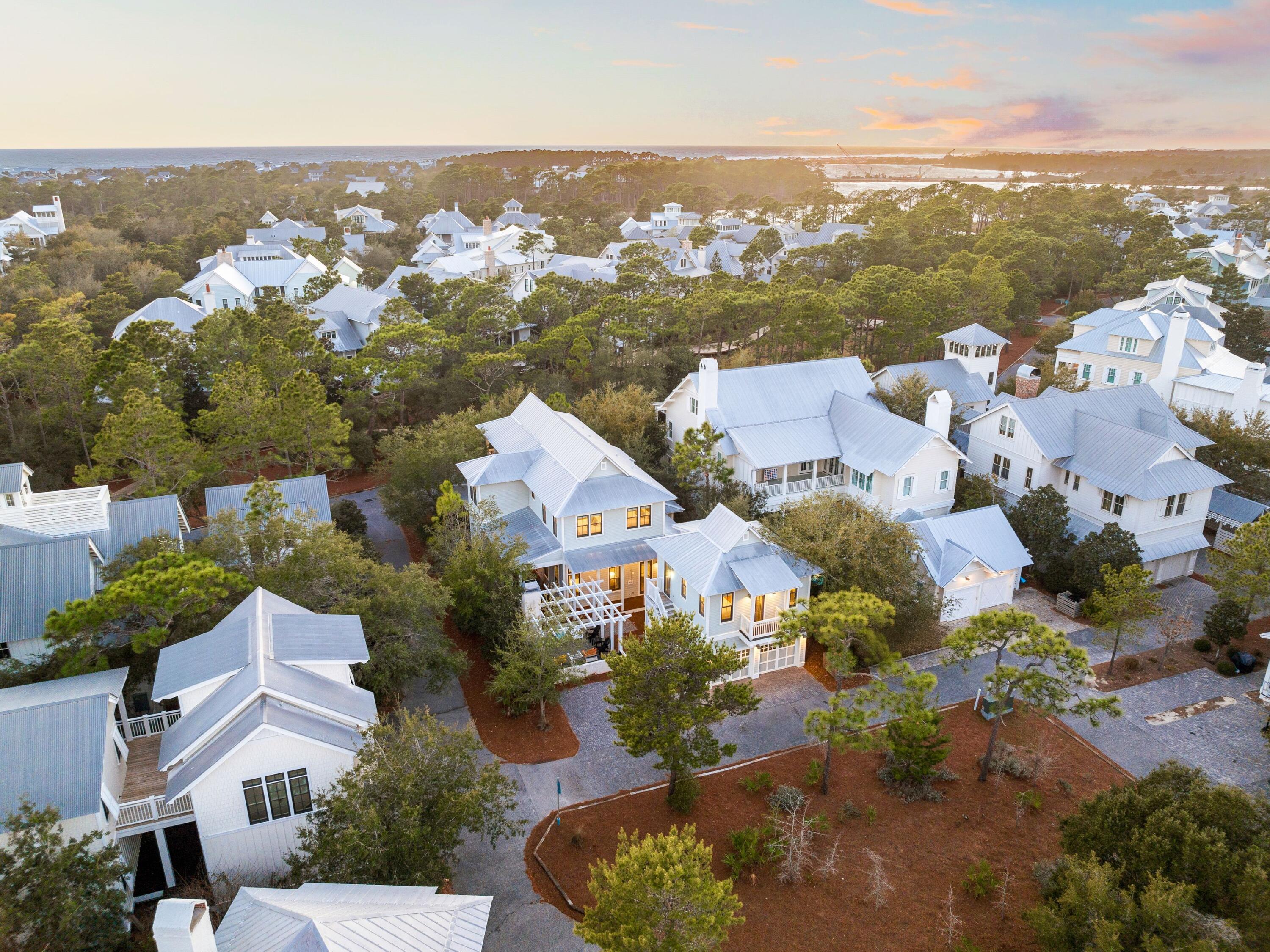 Tucked within WaterColor's prestigious Lake District, this stunning coastal retreat blends refined luxury with relaxed beachside living. Set on an expansive corner lot and spanning more than 3,700 square feet, the home is thoughtfully designed to balance elegance and everyday comfort. With five king suites, multiple living and dining areas, and a detached carriage house complete with a full kitchen, bedroom, bathroom, and living area with sleeper sofa, it offers ample space for hosting family and friends. This property has a proven track record as a strong income producer, generating $268,929 in 2022, $297,754 in 2023, and $309,773 in 2024, with $318,977 projected for 2025. From the moment you arrive, designer coastal décor, soaring ceilings, and rich marble countertops set a sophisticated tone. Deep covered porches invite morning coffee or evening wine, while the seamless indoor-outdoor flow creates a warm, welcoming atmosphere.
At the heart of the home, the gourmet kitchen features top-of-the-line stainless steel appliances, an oversized island with breakfast bar, and an elegant dining space perfect for gatherings. The open living area extends through grand doors to a private outdoor oasis. Designed for easy entertaining, the backyard includes a built-in kitchen with grill, Big Green Egg, and sink, along with an inviting outdoor fireplace and shower  ideal after a day at the beach.
Perfectly positioned just steps from the Frog Pond Pool and Sandhill Park, this prime location is minutes from Camp WaterColor, the Boathouse, the Beach Club, and the charming streets of Seaside. Whether as a primary residence, vacation retreat, or investment property, this exceptional WaterColor home delivers the best of 30A living  elegance, comfort, and coastal charm.