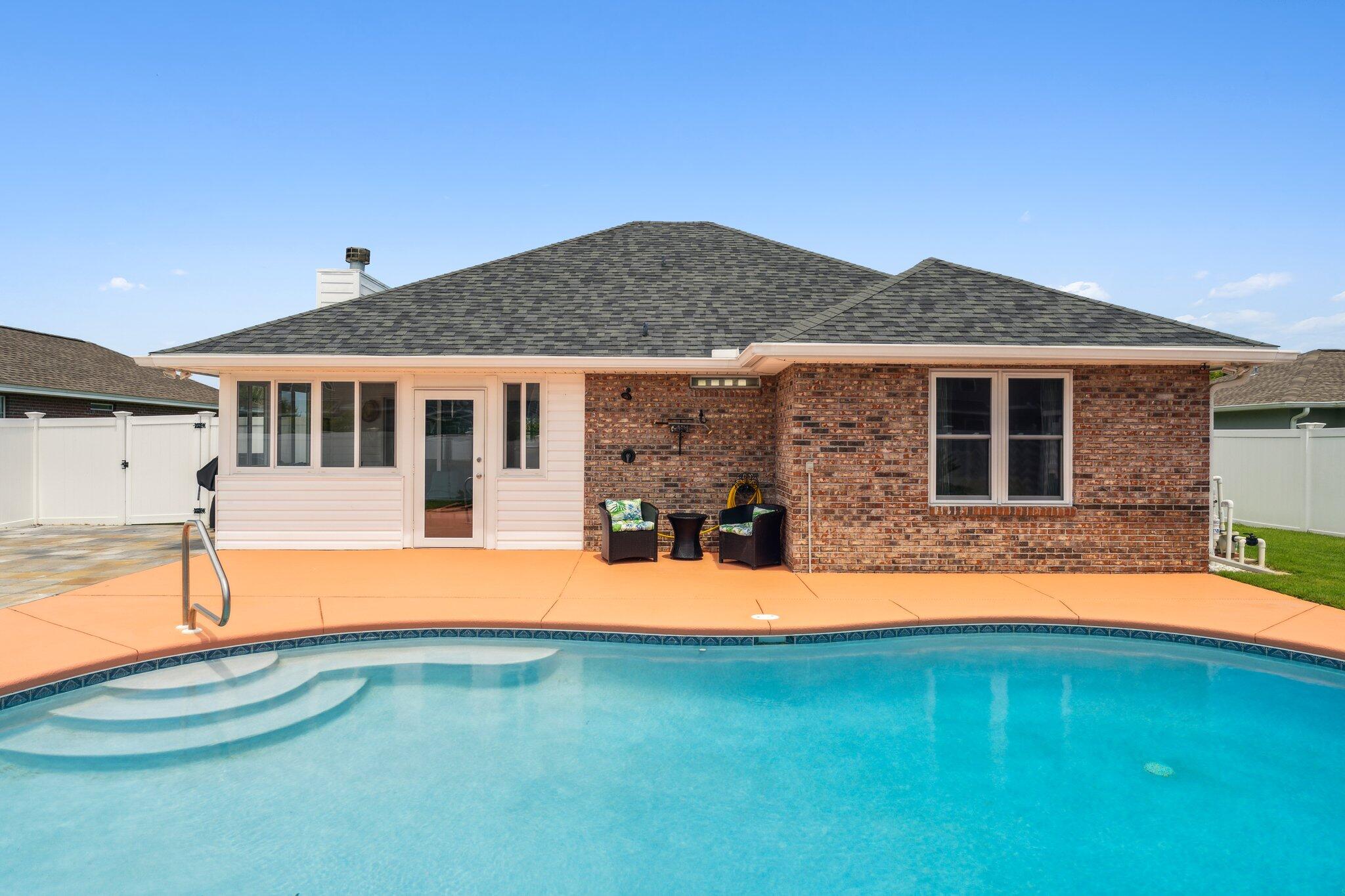 his beautifully maintained home located in the heart of Lynn Haven. This home boasts lush green landscaping and a newly resurfaced concrete saltwater pool enclosed in a 6 foot vinyl privacy fence with a workshop and beautiful pavers for outdoor entertainment! There is an enclosed Florida room on the back of the house giving the opportunity to dine under amazing western sunsets overlooking the pool. This home has tile, LVP and carpet throughout the house and a beautiful brick fireplace in the living room. The kitchen has tall windows looking out to the front of the well manicured front yard. The three bedrooms are spacious while the larger master bedroom has a large walk in closet and new walk-in tiled shower. 1714 Scarlett Blvd is centrally located and close to shopping, restaurants and medical services. The home is also only a short 20 minute drive to the most beautiful beaches in the country, 30 minutes to Tyndall Air Force Base and one block from Cain Griffin Park.