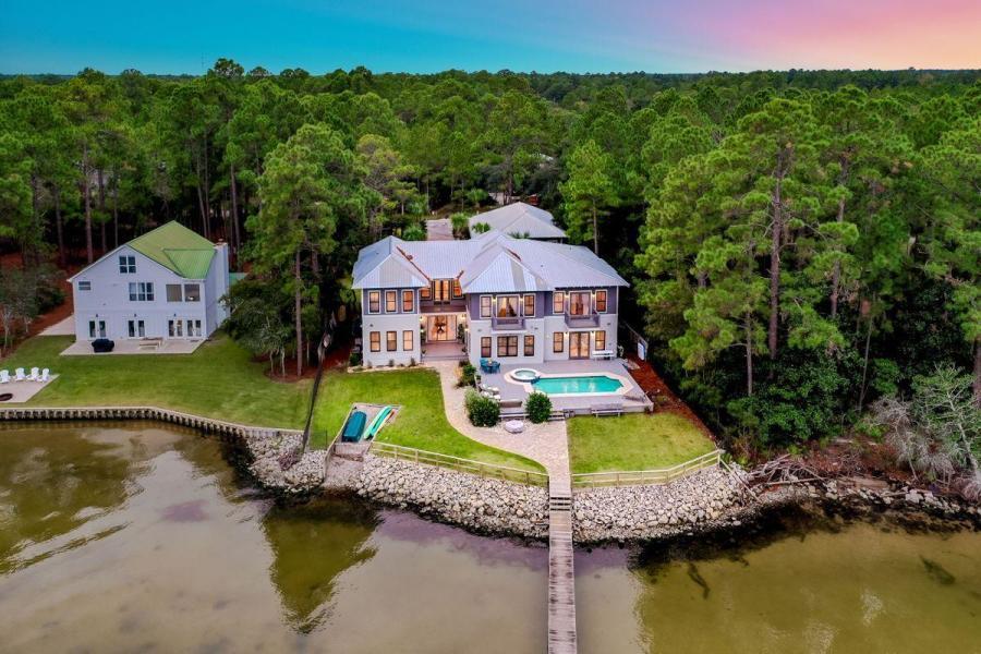 Exemplary bay front location presiding over 100' of prime water frontage juxtaposed ample privacy & serenity while offering close proximity to 30A and 331 in the heart of Santa Rosa Beach. This pristine family compound is finely appointed and ideally comprised of 6,300 sqft in the main house and over 1,500 sqft in the guest quarters primely situated on half an acre with notable features including a three car garage, spacious in ground pool & sun deck and private dock with boat launch. This incredible estate yields an unparalleled lifestyle with a sprawling structure that takes full advantage of the waterfront location. The main house offers an open floorplan with a spectacular entry foyer highlighted by direct bay views and a double height ceiling.