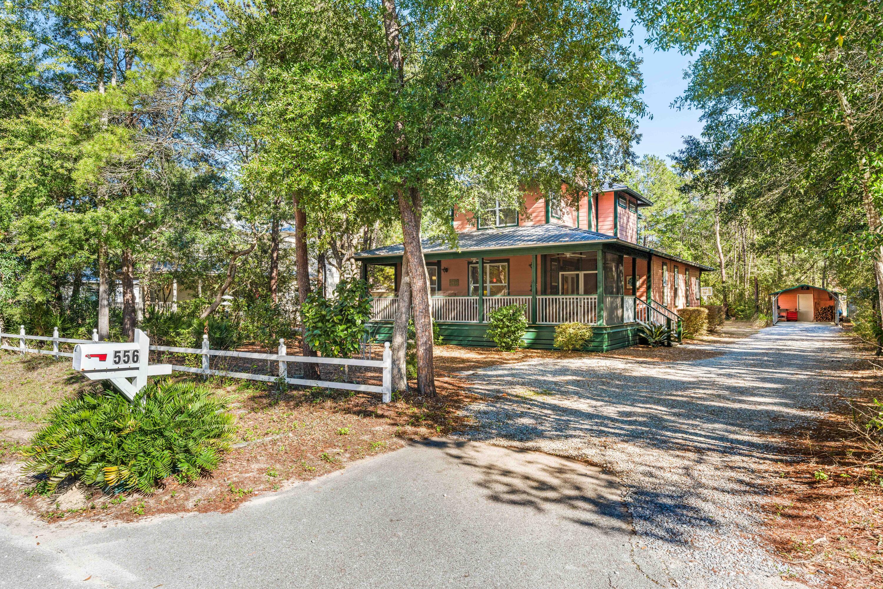 Just minutes from the beach, the Daughettes/Point Washington area is a quiet, rural, and woodsy community known for its soaring pines, magnolias, and scrub oaks. Nestled between the bay and the Gulf, this unique neighborhood offers a charm all its own. This thoughtfully designed home features an open-concept living, kitchen, and dining area on the first level, along with a powder room and laundry for added convenience. A screened-in front porch overlooks the deep, wooded front yard, creating a peaceful space to relax and enjoy the natural surroundings. The primary suite is located on the first floor, while the second level offers two additional bedrooms, each with its own ensuite bath, providing privacy and comfort for family or guests. A separate office or bonus space on the main level adds flexibility for work or leisure. Additional highlights include walk-in closests and pantry, a detached two-car garage with a heated/cooled office/workshop space, two carports great for boat and paddle board storage, and ample driveway parking. The backyard offers lots of design opportunities. Great place to call home!  Note- Newer A/C and Hot Water Heater