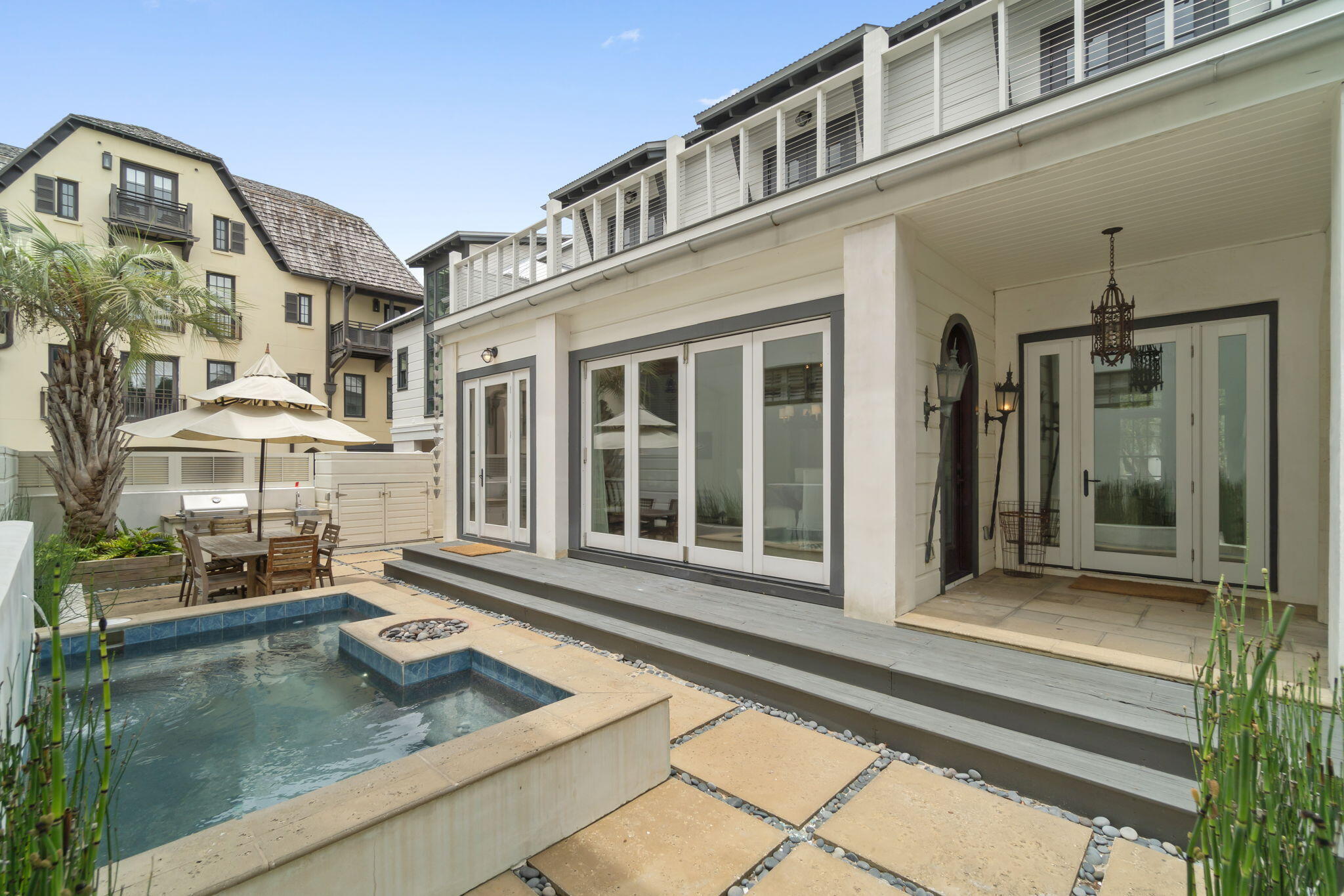 Fabulous & RARE New Price on Rosemary Beach Gulf Side Charmer with pool & Carriage House! This upscale French country cottage lives up to its chic reputation, along with its delightful '' honeymoon'' carriage house separated by a private courtyard complete with plunge pool and summer Kitchen!  The essence of smart design with warm natural light throughout, it's fabulous chefs' kitchen, dining & living areas gaze onto the covered porch, romantic courtyard & pool. The volume ceilings display crisp white vertical shiplap walls to compliment the beautifully curated furnishings & many design elements including peacock paver flooring.  The second level includes 3 bedrooms & baths plus a shared balcony overlooking the charming yard just steps away from Rosemary's Main Street. stylish natural wood spiral staircase leading to the recently expanded bedroom. There is a full bath & laundry area as well, Furnishings are equally "French countryside" in keeping with the main property. This charmer is always "in demand" for rental but also delights as a permanent residence. See this very special home at twilight & fall in love!