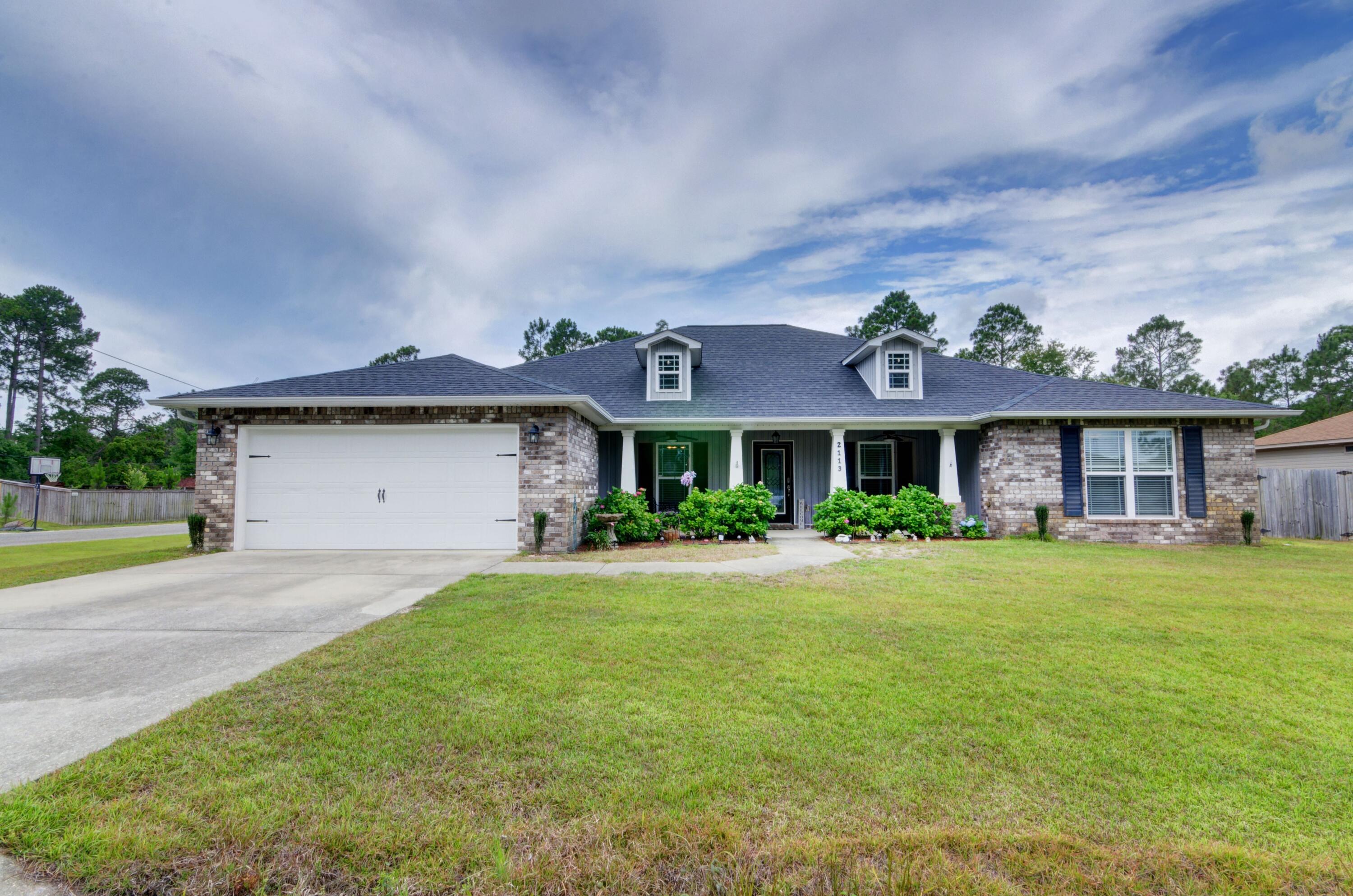 *Back on the market due to no fault of the sellers. Buyer cancelled unexpectedly a week before closing.* Welcome home to this beautiful move in ready Navarre home featuring 4 bedrooms, 2 baths, plus a formal dining room AND and office/flex room on a 0.45 acre corner lot! (the property line extends past the tree line!) Pull into the driveway and you'll love the welcoming and spacious front porch lined with blooming mature hydrangeas! Walk up to the glass front door and enter inside to take in the long entry hallway with a formal dining room to your left, and an office/flex space on your right complete with two sets of french doors and window treatments for added privacy. The luxury vinyl plank flooring is extended throughout the entire home with tile in the kitchen, bathrooms, and laundry room (no carpet at all!) and you'll love the freshly painted wall color! The living room has vaulted ceilings and is open to the well appointed kitchen featuring all granite counters with stainless steel appliances (the refrigerator and dishwasher are new) along with a farmhouse style sink with a touchless kitchen faucet and soft close drawers. There is a kitchen island great for prepping, and an additional hop up bar with drop down pendant lighting. The large master bedroom has a trey ceiling and overlooks the great backyard, with a bathroom showcasing double vanity granite counters, two separate walk in closets (complete with custom organizers!), a soaking tub, and stand up shower. The other three bedrooms are great sized in this split floor plan home with another shared bathroom also with matching cabinets and granite counters. From the living room the french doors take you out to a fantastic covered and screened in patio to enjoy overlooking the great backyard which leads to a firepit within the fully fenced in and irrigated yard. Other notable features include the double gates to accommodate a boat and/or RV, as well as a 10x11 shed with power as well as plenty of room to add a pool! All of this and just minutes from peaceful Navarre Beach - with no HOA fees! Conveniently located less than a 2 miles from A rated schools and a short drive to Hurlburt AFB.