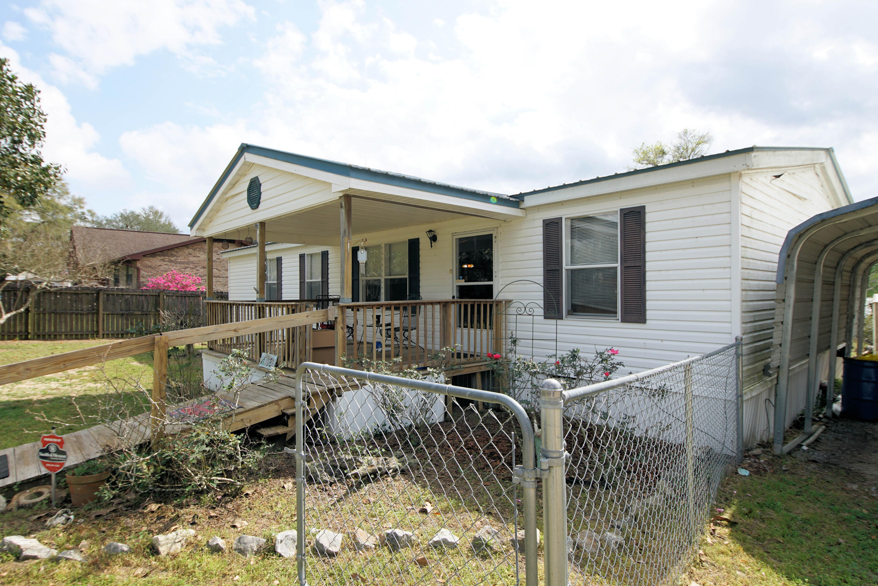 Vacation Rental!! Western sunsets over the beautiful Juniper Lake and perfect Florida weather in this 3 bedroom and 2 bath home with 1296 Sq ft! Built in 1998 this double wide mobile home sits on a double lot with approximately .80 acres of land and 160 feet of water frontage!! This home is perfect for a primary home, secondary/vacation home, or an investment property! The location of this home and dock provides for expansive views of the lake! The exterior of the home has a front, under roof patio (15x10), fenced in yard, three separate carports (12x20) and two sheds (28x20, 10x12)! The possibilities are endless! Build on the second lot, turn the large shed into a short term rental for extra income or add a space for RV parking!  In addition, this property is only minutes to the Juniper Lake Park and public boat ramp! This home has a metal roof and a new heating and cooling system (Bosch, 2022). In addition, there is long dock with a cover for a small boat, sprinkler system, and back porch! Enter the home and notice the vaulted ceilings and open floor plan! The living room opens to the kitchen and dining area! There is also a split floor plan with the master bedroom on one side of the home and the guest bedrooms and bathroom on the other side! The kitchen has a built in microwave, slide in stove and oven, dishwasher and refrigerator. The kitchen cabinets have crown and mirrored doors. The master bedroom has a soaking tub, walk in shower, and double vanity!  Don't miss out on this perfect waterfront home and double lot! Buyer to verify all dimensions and information!