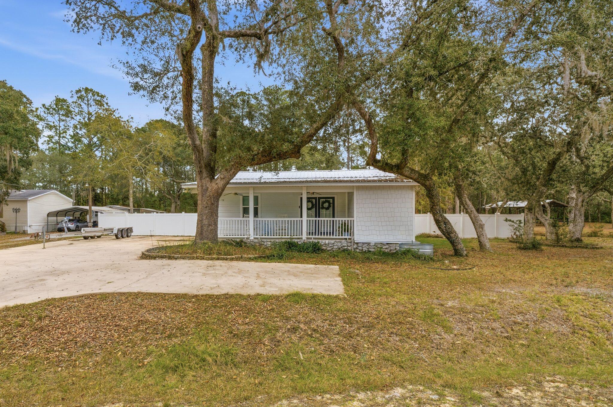 Opportunities like this are increasingly rare — nearly an acre of land paired with a comfortable 3-bedroom, 2-bath home designed for everyday living and long-term potential. The interior offers a bright, functional layout with welcoming living spaces that connect easily to the kitchen, making daily routines and casual gatherings feel natural. Bedrooms are well sized and flexible, with the primary suite featuring its own private bath. Outside, the expansive yard provides space to relax, entertain, garden, or expand, all framed by mature trees and open green space. A property that delivers privacy, versatility, and room to grow in a convenient Freeport setting.