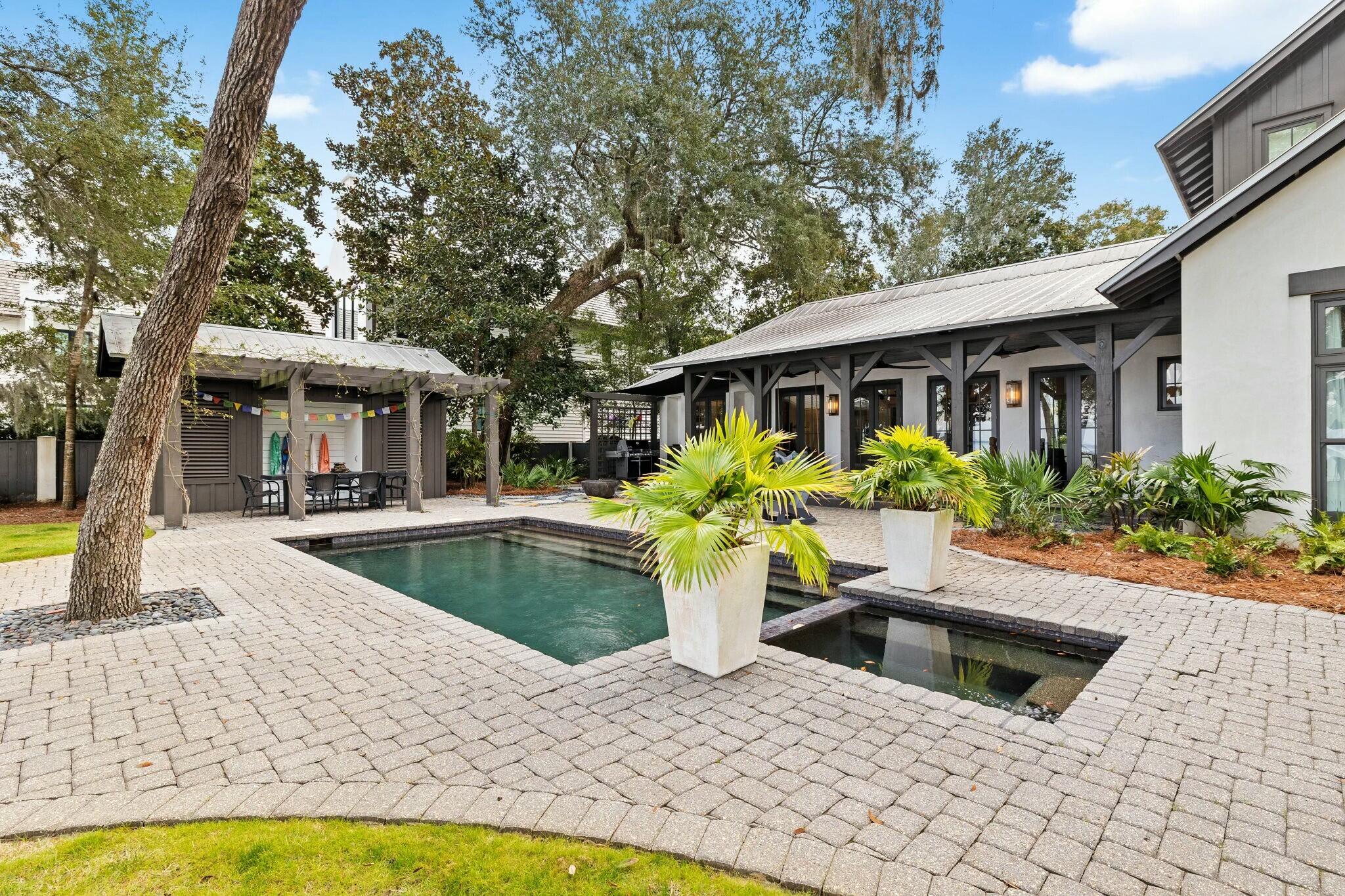 Discover unparalleled waterfront living in this stunning Bay Front estate with 100 feet of private water frontage on the Choctawhatchee Bay, located in the exclusive gated community of The Estuary. Designed by Tammy Massey and built by Arkon, this concrete-built home showcases timeless elegance with breathtaking bay views, a private pool and pool house, and a covered boat slip with a dock.

This exquisite property features 5 bedrooms, including a main-level master suite with vaulted ceilings, floor-to-ceiling windows, and expansive views of the bay. The master bath boasts an oversized dual vanity, frameless shower, soaking tub, and a spacious walk-in closet with custom built-ins. The second level offers two large bedrooms, each with en-suite baths and stunning north-facing views of the