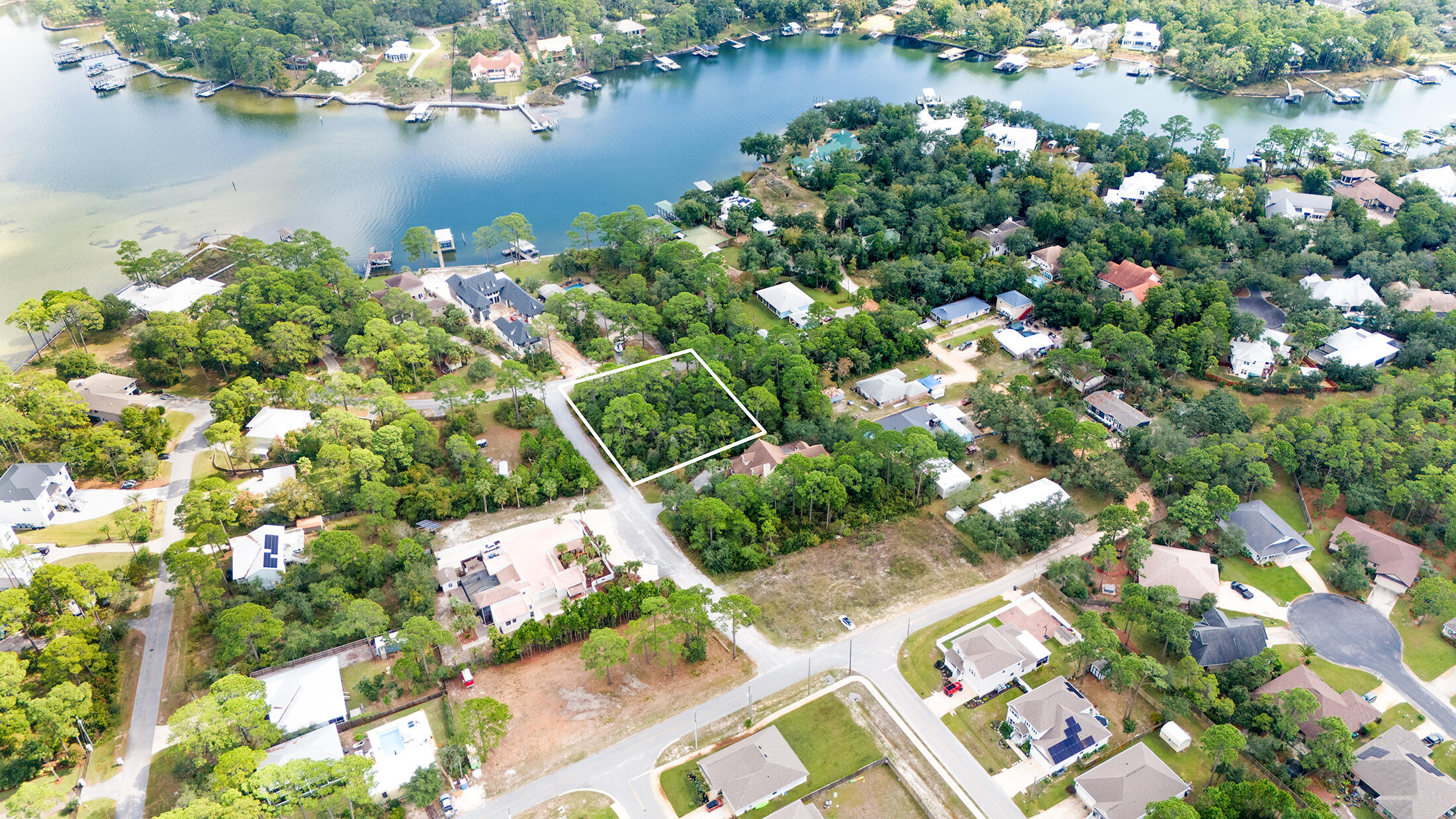 ** Rare Opportunity of Land in Santa Rosa Beach, across from Bayou, Potential Water view**Build your dream home on this large 1/3 acre wooded corner lot just across from Hewett Bayou with potential Waterview, and the freedom of no HOA and no build-out time!!  This prime corner location homesite offers peaceful surroundings in an established beautiful waterfront neighborhood, all within a few minutes drive to endless shopping, dining options, local hospital, multiple state parks, and the sugar sand beaches of 30A.  Looking for build ideas? We have established builders with ready to build site plans ready to bring your vision to life. Make your dream of living by the beach come true. Call today.