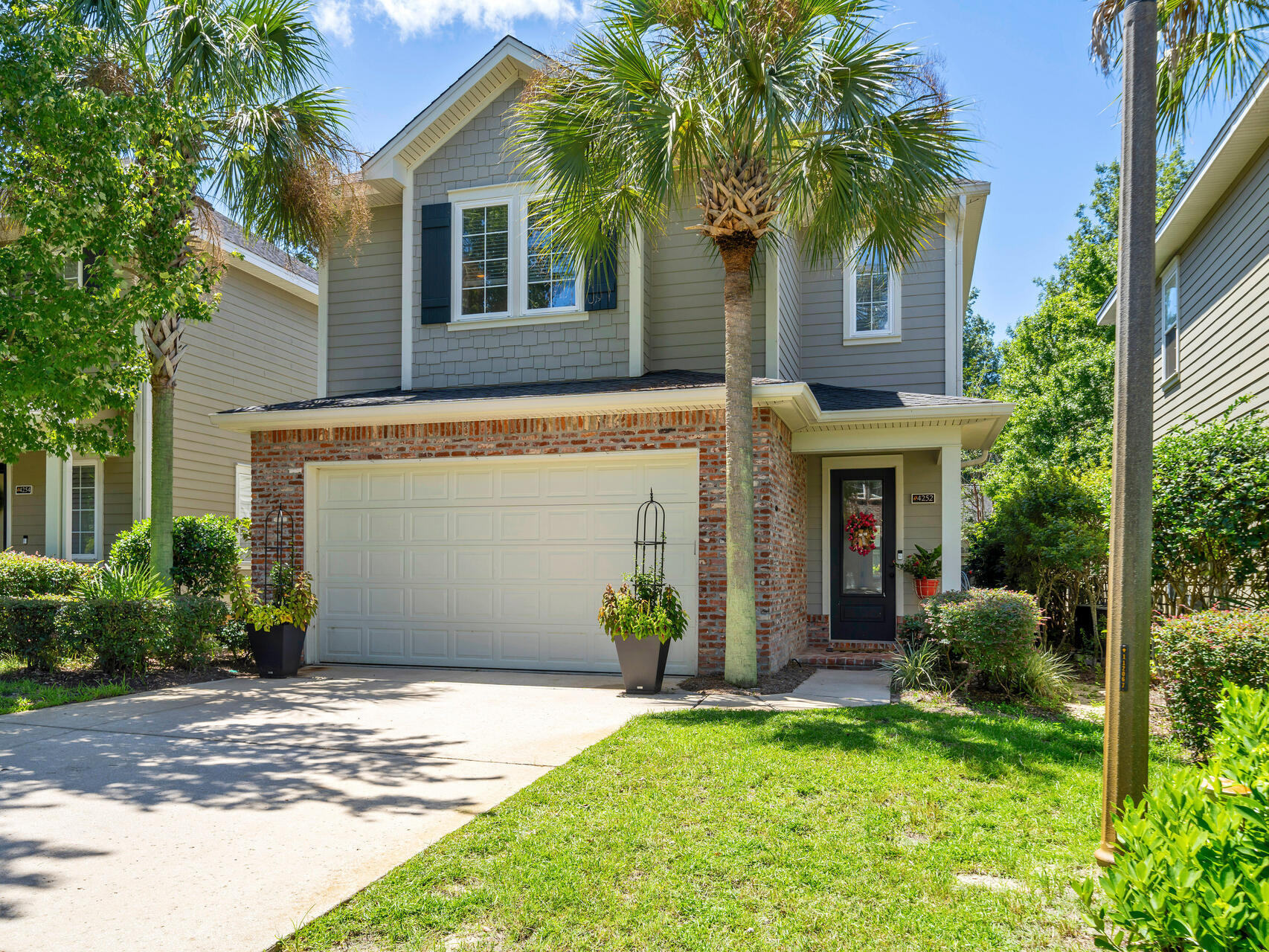 Beautiful maintenance free home located in the private community of Marina Landing. This Huff Homes community is conveniently located just steps away from the Bluewater Bay Marina complex. When you enter this home through the lovely foyer you will be sure to notice the beautiful hardwood flooring, 9' ceilings, crown molding and updated lighting fixtures. The open floorplan features a large living area open to the efficient kitchen and dining area. The kitchen features stainless appliances including a gas double oven. Behind lovely French doors adjacent to the living area, there is also a convenient office that can be utilized many different ways. Upstairs you will find a convenient loft area, two additional bedrooms, a full bath and the master suite. The master suite is large enough to accommodate oversized furniture and the master bath has a HUGE shower! The tidy back yard is the perfect size for a buyer who does not want to spend their weekends doing yard work!  Come and take a look at this move in ready home that can be yours!