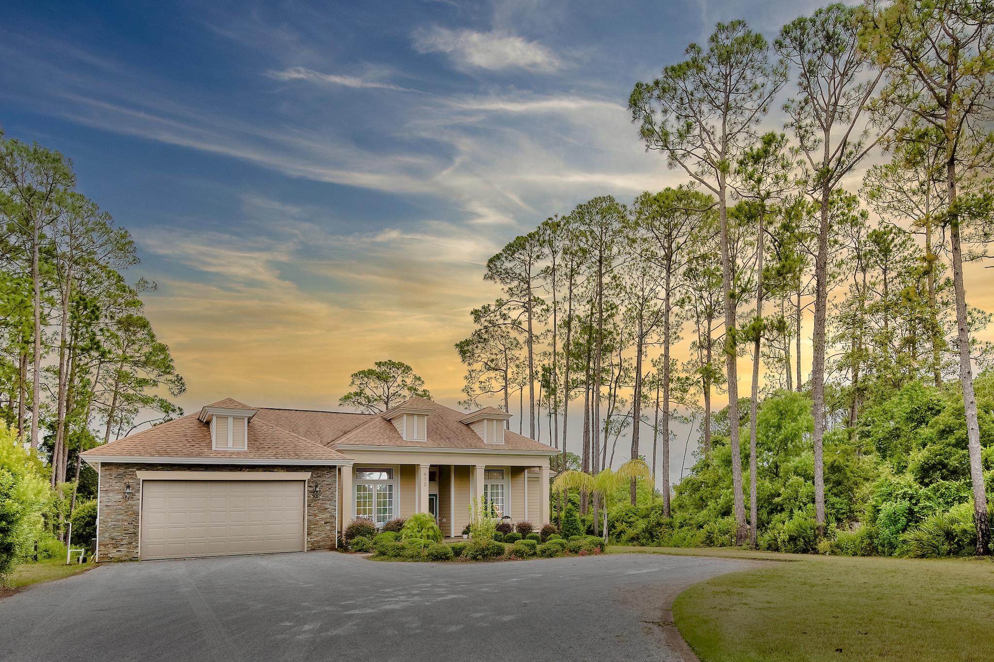 612 Walton Way

Half Acre lot in Miramar Beach with golf course views, lush natural surroundings, and no HOA. This 4 bed/2 bath home features a large, private backyard with a partially covered 14' x 45' deck, and more than enough room for the addition of a pool. Inside you'll find a split bedroom plan with 12' and 10' ceilings, fireplace with stone veneer, solid wood cabinets, real wood and travertine floors, and granite countertops. The master and two well-appointed guest rooms boast walk-in closets, and the master suite includes a Jacuzzi tub, his and her sinks, and a walk-in marble shower. This 2015 construction includes high-end finishes such as Kohler plumbing fixtures, hardy board, impact glass on the windows and doors, crown molding, coffered ceiling in the dining area, as well as elevated arches throughout. Just across from the bay, the beaches are a quick drive away, yet breathtaking views of the neighboring award-winning Emerald Bay golf course can be taken in directly from the peaceful, private deck.