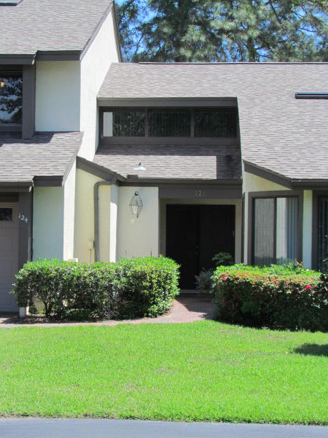 This modern townhouse in desirable Bluewater Bay is the epitome of the open, airy, bright home so in demand in this region.The interior is absolutely gorgeous and has been recently updated with high end details. The kitchen can only be described as state of the art, with plenty of counter space and all stainless kitchen appliances being updated just last year. Plenty of counter space, seating at the large island and an eating area make this a perfect kitchen for entertaining.You will love the recycled glass counters and the beautiful gourmet hood and backsplash. The flooring is stunning wood look tile, so no worries about scratches or water damage.The huge great room features a lovely fireplace and plenty of room for the largest furniture. The tongue & groove ceiling is straight out of a designer magazine. The lovely golf course views can be seen from the family room and from the large screened in porch which opens out onto the paver patio. Imagine all of this beautiful landscaping without doing the yard work yourself! The first floor master bedroom is large and also has access to the secluded patio. The master bath has also been recently updated and the tile in the bath and shower is lovely. Upstairs you will find two additional bedrooms and another room without a closet that could easily be a 4th bedroom, den or exercise room. A full bath is shared by these bedrooms and the large walk in closet in one of them includes a beautiful medical grade sauna, perfect for relieving back pain from a long day of golfing! There are many other upgrades too numerous to mention and the pictures do not do this home justice. You really want to see this one before it is too late!