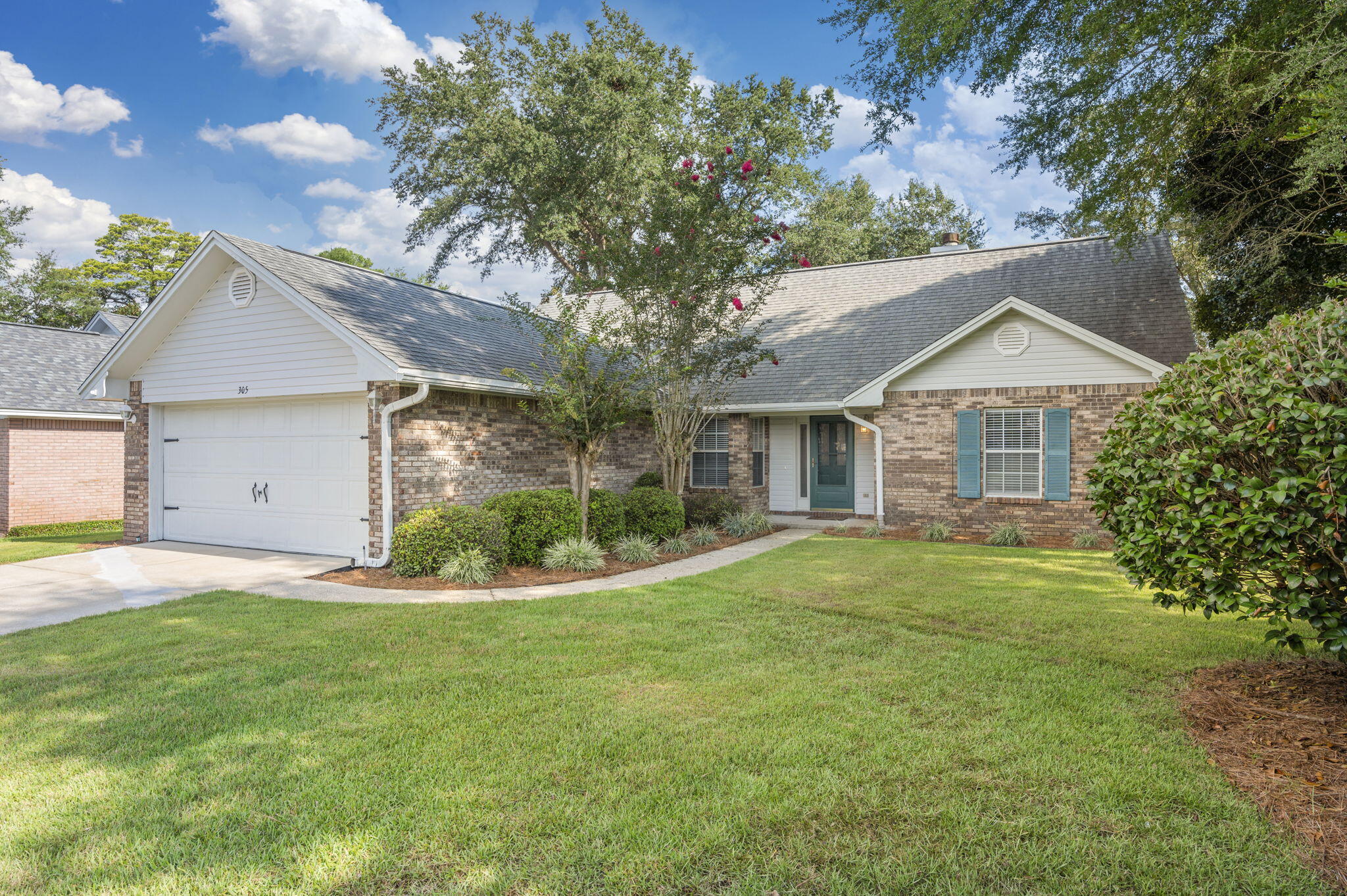 Welcome to this beautiful brick home located in the desirable Bluewater Bay community. This 3-bedroom, 2-bath residence offers a thoughtfully designed layout with both style and comfort in mind. Step into an inviting entryway with recessed lighting and luxury vinyl plank flooring, leading to a cozy carpeted living room featuring a stunning fireplace and mantel. The dedicated dining room boasts two windows overlooking the front yard, perfect for enjoying natural light during meals. The fully appointed kitchen includes stainless steel appliances, a gas range, custom island, stone countertops, and a window above the sink—ideal for both everyday living and entertaining. The spacious primary suite is conveniently located on the first floor and includes a dual vanity bathroom with a custom tiled walk-in shower and glass enclosure. The two additional bedrooms are carpeted with ceiling fans and share a guest bath with a tiled shower/tub combo and stone countertop vanity. Upstairs, a bonus room offers flexibility for a home office, playroom, or guest space. Enjoy year-round relaxation in the large screened-in Florida room, which opens to a beautifully landscaped backyard with mature trees, a privacy fence, and a wood deckperfect for outdoor entertaining. Ready for immediate move-in...Contact us today for a showing!!!