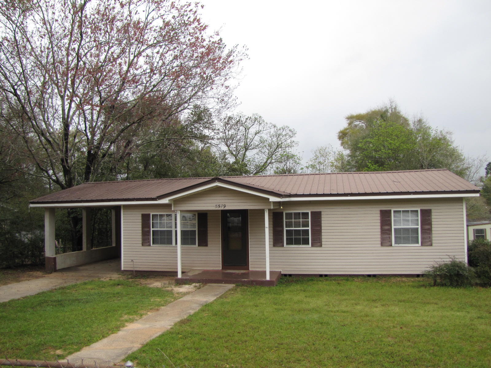 This home is available for immediate occupancy. The large eat-in kitchen has stove, refrigerator, and dishwasher. The home has original hard wood floors throughout and knotty pine paneling on the walls. There is a utility room in the carport for washer and dryer. The yard is entirely fenced. No smoking or pets allowed.
