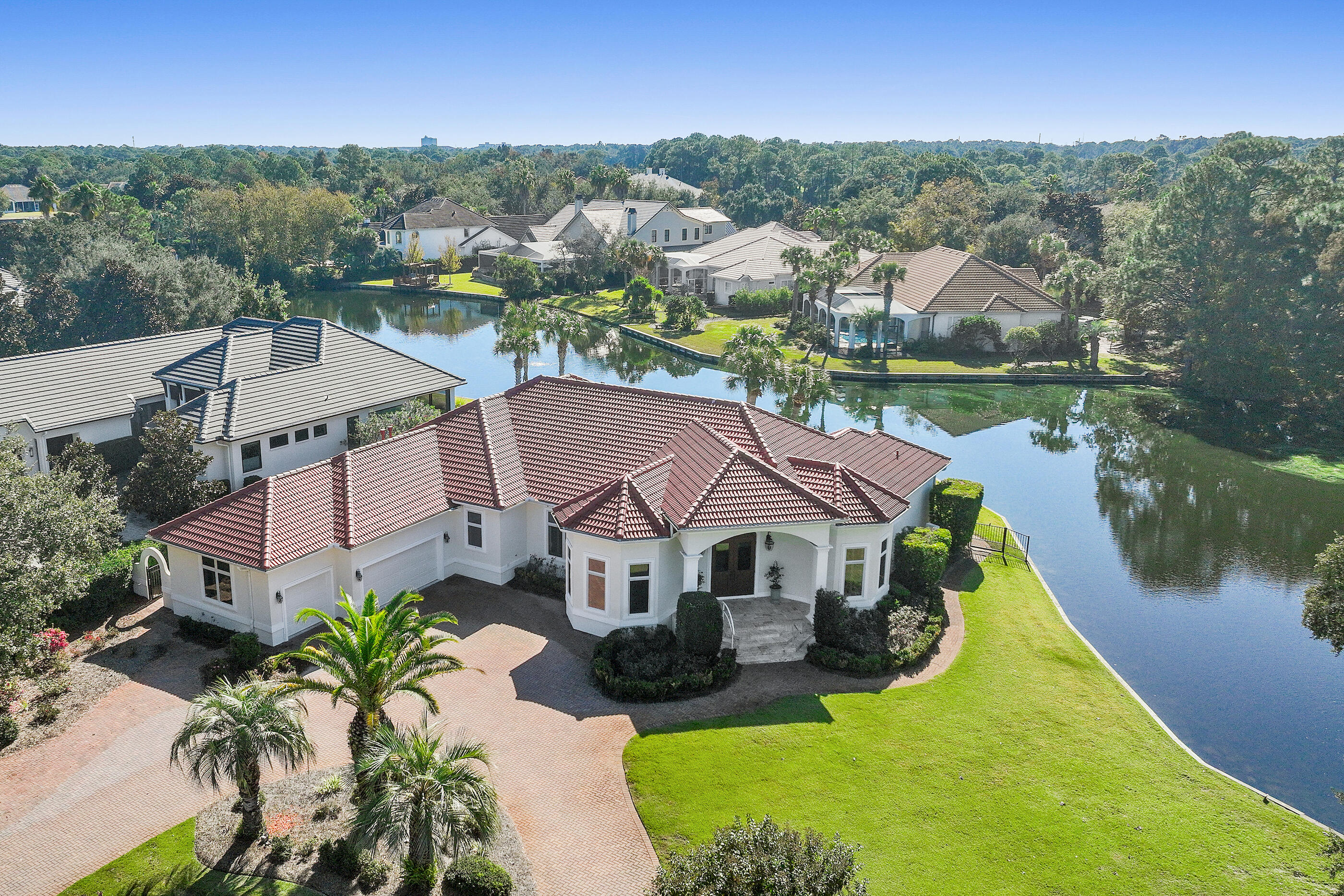 PRICE IMPROVEMENT! Motivated sellers have just reduced this stunning lakefront retreat to $1,350,000 -- an exceptional opportunity at a new price point. Don't let this one slip away!

For the Professional Who Works From Home & Actually Wants to Live There Too! 

This isn't a cookie-cutter house. It's a custom-built sanctuary for how you actually live.

You didn't leave the cubicle to work from your kitchen counter.
This home gets it: A real office with a real door. Walls that muffle the chaos. Space that says 'I'm working' without you having to say a word.
The layout isn't strange--it's strategic.
Your master suite on one side. Peace. Privacy. Direct pool access for morning coffee in quiet--or that call that needs your full attention. The kids' two ensuite bedrooms on the opposite wing. T The kids have their two ensuite bedrooms on the opposite wing. Their own space to grow, host friends, spread out. Everyone has their retreat. Everyone has their dignity. And you? You have boundaries you can actually maintain.

Formal living and dining rooms for the client meetings that matter. A generous kitchen with breakfast nook flowing into the family room all opening to your covered lanai and sparkling pool. This is where Friday night dinners happen. Where laptop closes and life begins. Where you decompress after closing the deal, making the deadline, crushing the goal.

Step outside: nearly half an acre on a serene 5-acre lake in Regatta Bay. This is where creative blocks break. Where kids grow up barefoot while you build something meaningful. Where "taking a call by the water" isn't a vacation it's Tuesday.

The private sauna? Because professionals and parents both need to recover.

Peace of Mind Included:
New roof (hello, lower insurance premiums), new HVAC, new water heaters, new pool pump. The bones are solid. The systems are fresh. You get to move in and make memories not service calls.
Three-car garage. Circular driveway with room for the guests, friends, and family who make life rich.

This home was custom-built for families who refuse to choose between career and connection. Where parents can close a deal and make it to the pool by 4. Where Sunday brunch doesn't compete with spreadsheets. Where work supports life not the other way around.

This home was custom-built for someone who works differently. Lives intentionally. Refuses to settle for "good enough."