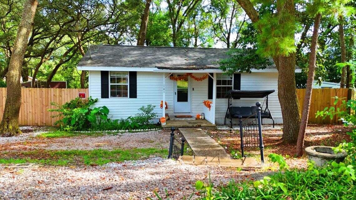 Nicely renovated 2 bedroom  Florida cottage with modern comforts and plenty of privacy.  It backs up to the 12th green of Eglin Golf Course. Enjoy the modern decor of wood look flooring throughout, and a kitchen with granite countertops and stainless steel appliances. The bathroom features a stylish tiled tub surround and a newer glass door. Relax in the screened porch that enhances privacy and take advantage of ample space for boat or RV parking. No HOA. The backyard has easy-to-maintain astro turf,  2 sheds, and a fire pit perfect for family gatherings. With a newer roof (2016), HVAC (2013), and water heater (2017), move in ready. Why buy a condo when you can own this private cottage style home  with classic charm and contemporary updates.  To be sold As Is With The Right To Inspect.