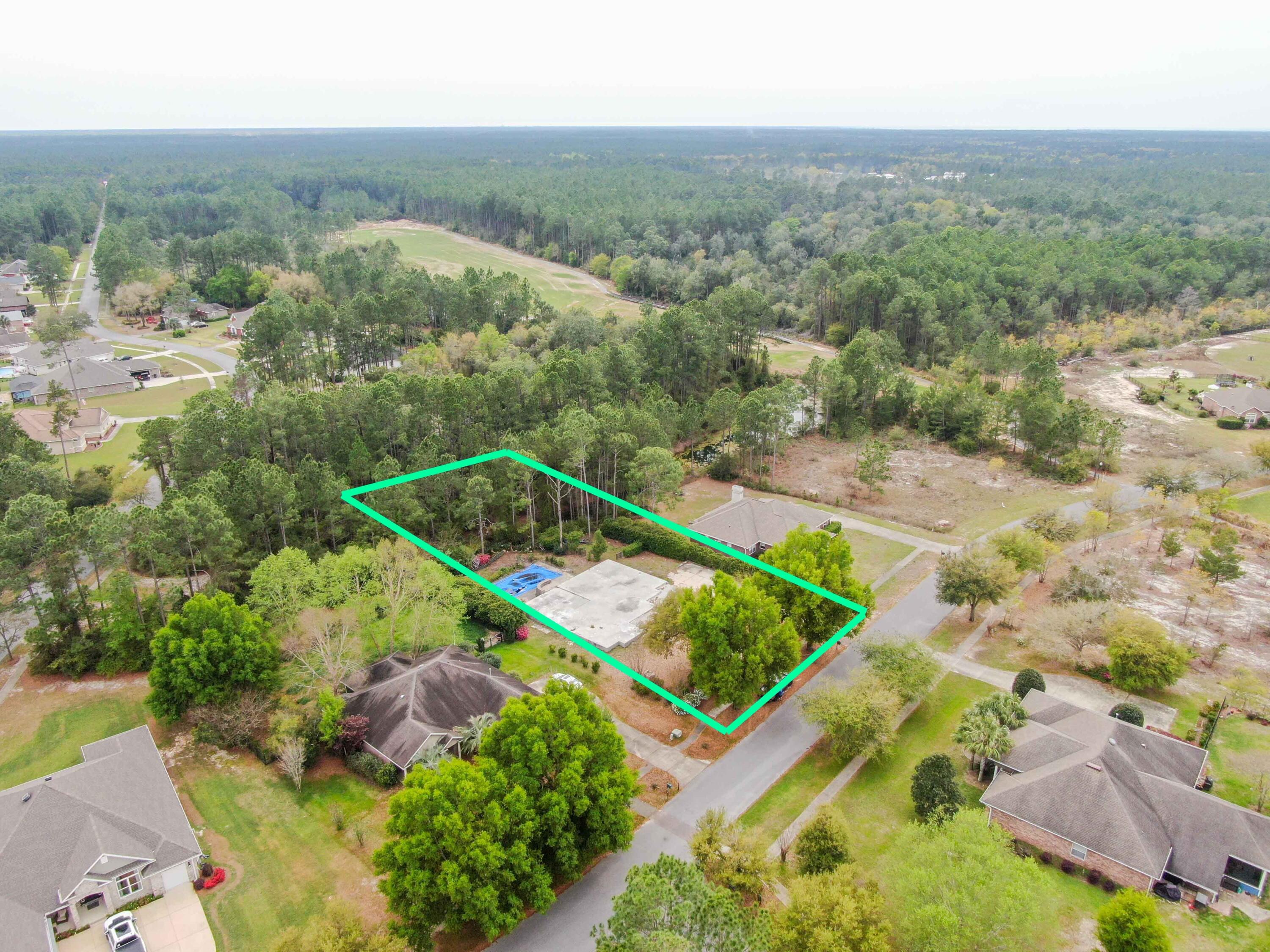 Welcome to the beautiful, gated community of Windswept Estates surrounded by the 5-star, 18-holes Windswept Dunes Golf Course. Located just 20 minutes to the gorgeous, white sugar sand beaches of Santa Rosa and Destin. This spacious .49 acre vacant lot is nestled near the entrance of the community with a wooded backyard. Lot is nicely landscaped and partially fenced. Shallow well for irrigation and a septic in place. This lot offers an in-ground gunite swimming pool surrounded with brick pavers and a disassembled screen enclosure for the pool. In-ground propane tank on site. CMU slab foundation ready for new build. Full set of engineered plans included for rebuild with option to alter. Plans consist of first floor area to be 2,606 sq ft and an upstairs bonus room which will add between 400-600 sq ft extra sq ft. Many amenities are offered in this community to include a basketball court, tennis courts, clubhouse, playground, fishing pond with dock, walking trails, swimming pool and weekly food trucks. If you're looking for a jump start in the building process, this is it, complete with previously installed pool.