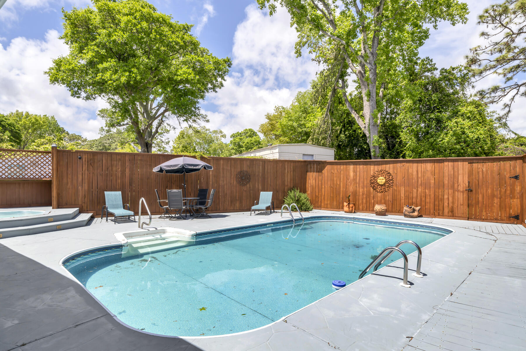 Private Pool home bursting with curb appeal! Well maintained home features 31 x 41' pool patio surrounding a sparkling pool and a 13' x 15' hot-tub deck.  Relax in the heated/cooled sunroom overlooking the pool. Enter the front foyer to find a large 17' x 16' eat-in kitchen and quartz counters with a center island and stainless refrigerator, sink and dishwasher.  Plenty of room for a table or dine at the breakfast bar.  Large windows bathe the home in natural sunshine. Custom white built-ins flank one wall and TV conveys.  Tile and laminate flooring throughout for ease of maintenance.  En-suite Master bath features a large walk-in shower, built-in seats and skylights.  Kitchen opens to the living room to enhance open-concept living.  Roof and pool liner each 3 years old.