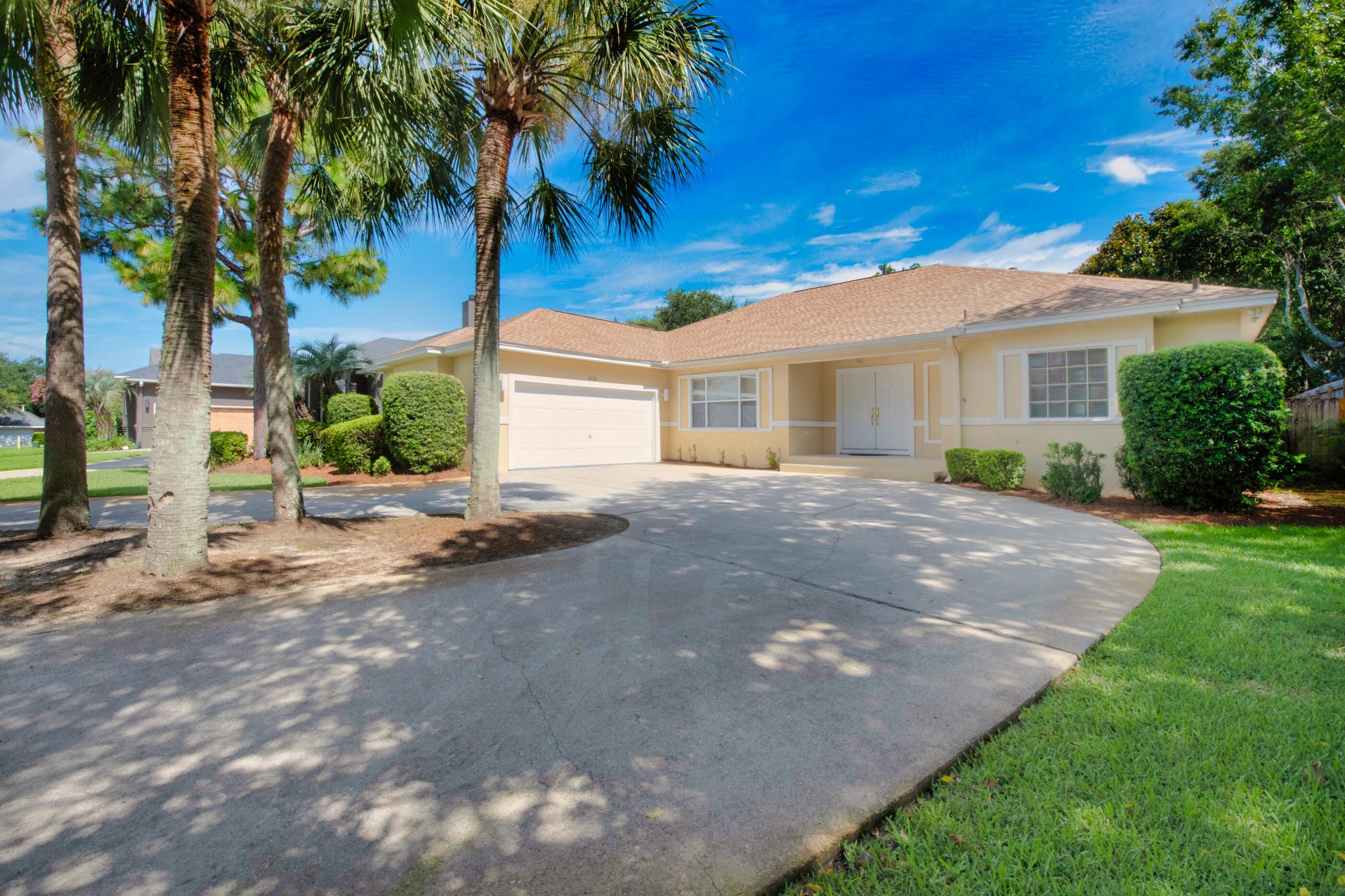 Discover the grand lifestyle at this contemporary custom-built home boasting timeless appeal and peacefully situated on a cul-de-sac. Arrive at a generous circular driveway that is surrounded by lush designer scenery consisting of a tropical landscape that is concluded by a side entry garage and covered front porch with aesthetic tiling that leads to the double door entrance.  As you enter, you'll notice the dramatic open living space consisting of neutral colors, durable tile and hardwood flooring, a vaulted living, and 9-foot ceilings throughout that give the space a blissful stylishness. Your guests will come together in the wide-open space of the formal dining and family room that are separated by a stately column. The sunken family room features plant ledges, a gas fireplace that serves as the focal point accented with track lights and extended to the vaulted ceiling. The cozy room with two large double doors gives way to sufficient natural light and brings the outside in for added enjoyment. The kitchen is beautifully presented surrounded by white cabinetry, a center island, built in wall oven, new refrigerator, large pantry, and hop up breakfast bar area that overlooks the eat in kitchen. Across the hall, there is a sizeable, dedicated laundry room that leads to the oversized two-car garage. The floorplan is most suitable with its split bedroom design that is ideal for guests or large families. The right side of home is dedicated to the master abode and displays ample space, private access to the outdoor lanai, and adjoining ensuite. With its spa-inspired vibe, the master bath incorporates superb functionality with its double walk-in closets, oversized walk-in shower that oversees the garden tub, and double vanity sinks. Opposite the home is the remaining two guest rooms that share a full guest bath complete with a shower/tub combo.   Through any of the double doors, your welcomed to the beauty that extends to the outdoor terrace where you will discover a large, covered patio flanked with ceiling fans for hot summer days and ample space for a large patio set. Enjoy nature while surrounded by a courtyard of lush landscaping that provides the perfect serenity. Enjoy your favorite game of cornhole or enjoy get togethers grilling out with friends amidst the shaded landscape. This home has undergone many recent upgrades in 2022 including new water heater, roof, lawn pump, HVAC, landscaping, and some kitchen appliances. Other amenities include a security system and whole house central vac. This thoughtfully crafted classic home awaits your arrival for the new lifestyle you've been waiting for! Call today for a private showing!