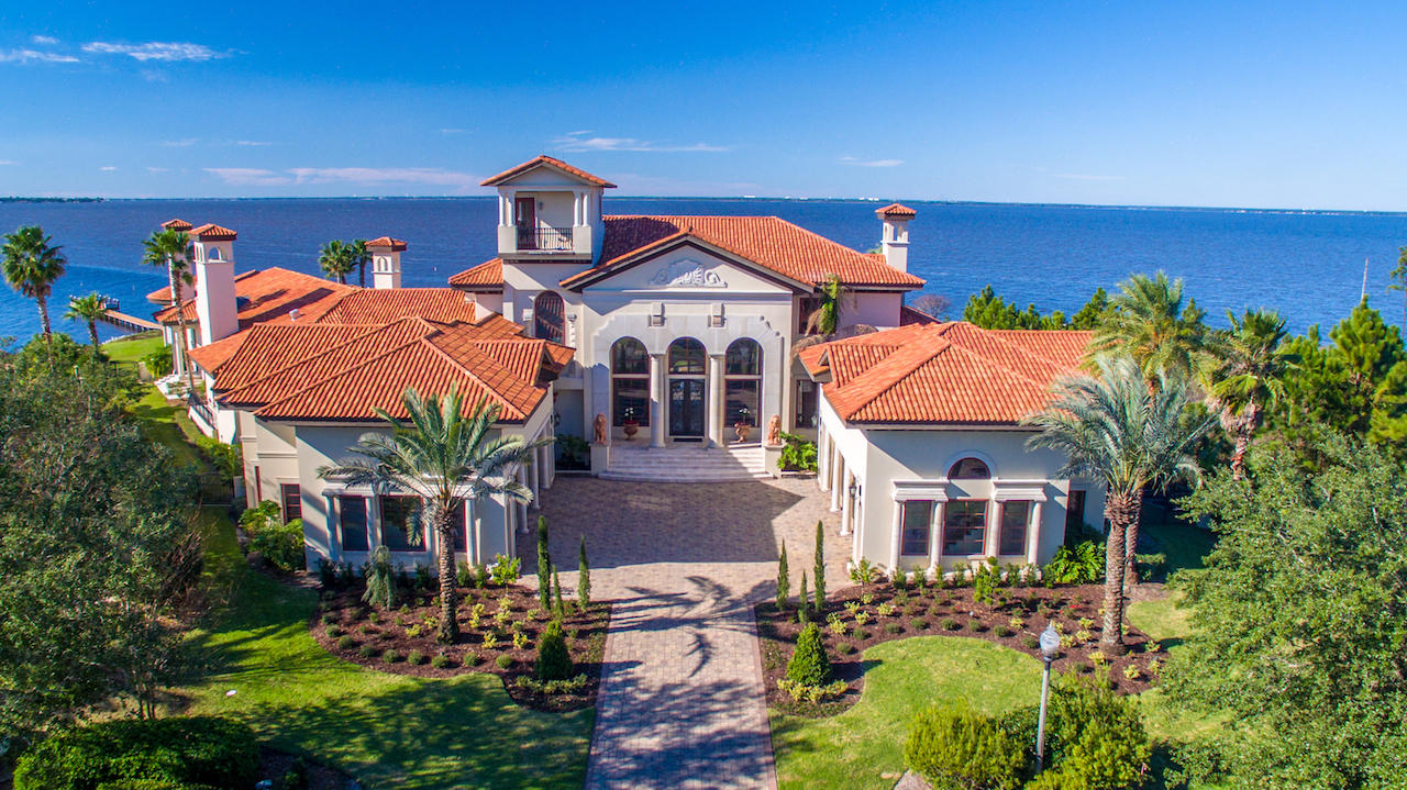 FEATURED ON HGTV'S EXTREME HOMES!! DRASTIC PRICE REDUCTION FOR RAPID SALE!! Welcome to 4300 Breakwater Drive, Destin, Florida's Most Prestigious Waterfront Estate! This magnificent home is of a spectacular Tuscan Villa style that is truly a work of art! Situated on indisputably the finest bay-front lot in all of Destin, the sprawling 1.8 acre estate is located in the exclusive gated neighborhood of Waterford in Kelly Plantation and is a masterpiece beyond compare, with over 410' of water frontage on the Choctawhatchee Bay and Jones Bayou. Custom built using the finest of materials and technology, this estate reflects elegance and sophistication. A brick-paved motor court leads to the dramatic arched limestone entrance, flanked by two lion sculptures and iron Cantera doors... The grand foyer has dual stairways, each with hand railings complementing the styling of the front doors, and allows for direct views through to the expansive pool pavilion with the ultimate backdrop: the serene Choctawhatchee Bay waters! The first level features an open, inviting floor plan that is perfect for entertaining. A formal living and formal dining room flank the grand foyer. The dining room opens to a large wet bar with commercial grade 3' x 5' walk-in cooler and the family/casual dining area/kitchen. A round floor-to-ceiling saltwater aquarium is just one amazing focal point of this magnificent space. The gourmet kitchen would please the fussiest cook, with plenty of custom cabinetry, professional-grade appliances, and double-stacked granite counters. Just beyond the family room and visible from the kitchen is the home theater room, featuring stadium seating and 113' wide screen. The luxurious master wing has a large bedroom with three televisions mounted to the ceiling over the bed, a waterfront sitting area, a fireplace, a sumptuous bath with a sunken, two-person Jacuzzi tub, a large walk-in shower, double vanities, and two walk-in closets. Two additional bedroom suites are on the first level, as well as an exercise room. Take the stairs or the elevator to the second level to find three additional bedroom suites, a wet bar and adjoining den, a massage room, a large storage room, two offices with a private entrance, and a large balcony overlooking the bay and pool area. Step outside on the first level to a tropical oasis, with a beach-entry pool, a fountain with swim-up bar, and a lanai with summer kitchen and fireplace. Stacking sliding glass doors open from the family room, formal dining room, and living room onto the lanai, expanding the living and entertaining space. There are two garages; the north garage can accommodate six cars, while the south can accommodate three. In addition to the main house, a guest house over the north garage has two bedrooms, a full kitchen and living area, and a private entrance. So much thought went into each and every detail of this magnificent home! Every aspect of this interior has been finely appointed throughout with ruffled travertine floors, alder doors, hardwood floors, trayed ceilings, and dome ceilings. Also includes heated pet rooms with doggie doors; a commercial-grade sprinkler system; a geo-thermal heating and cooling system; smart house technology so that the touch of a button can change the lighting, pull up the weather forecast, view your exterior security camera angles, or to tune in to a favorite style of music on keypads throughout the home; and much more! Of course, the grounds feature lush landscaping, as well as a boat dock with slips. A property of this caliber is a rarity and will certainly be admired by discriminating ownership that demands the finest detail money can buy! Buyer(s) must verify the accuracy of all information and specifications. L.O.M.A. available.