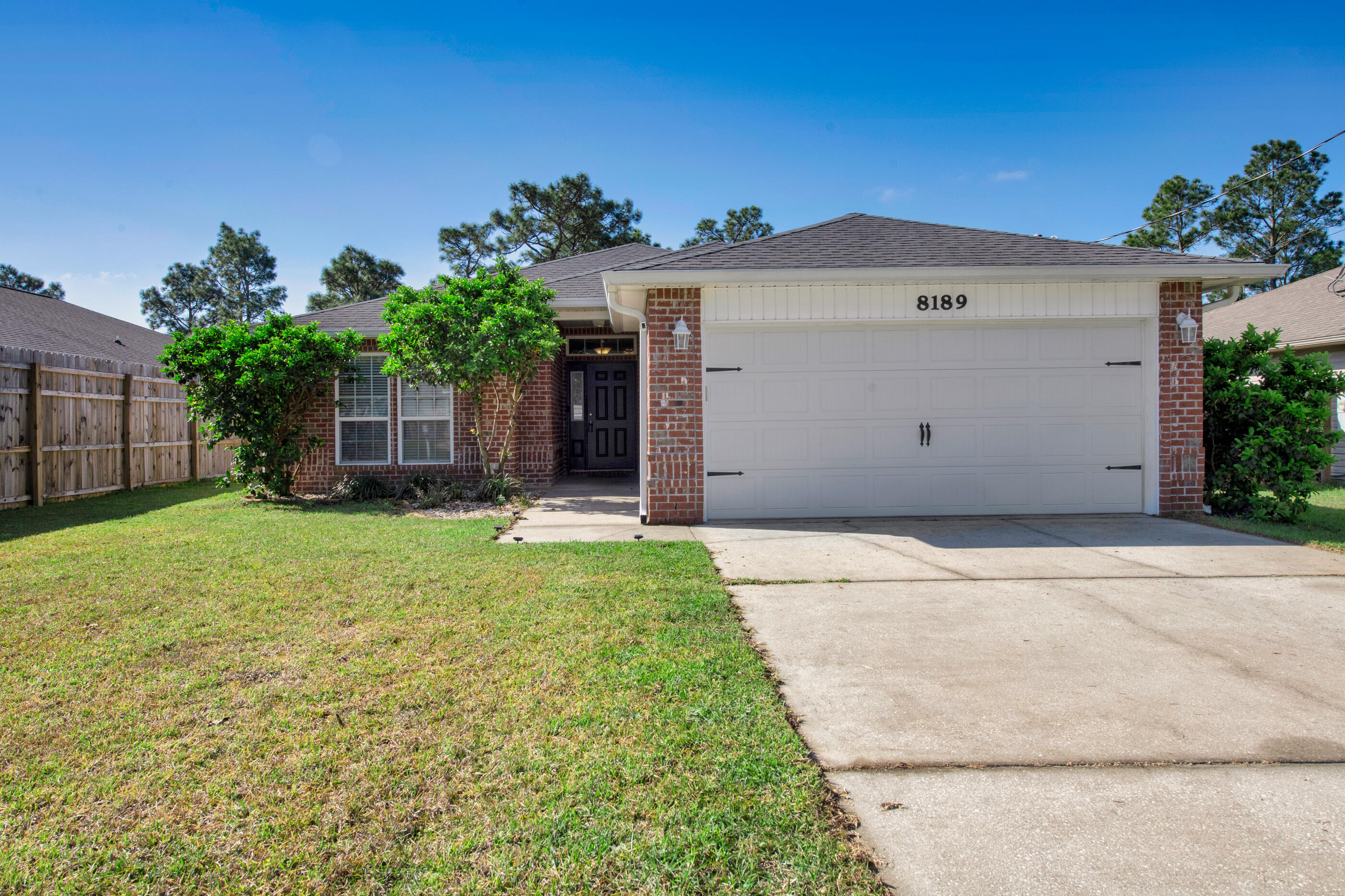This home is IMMACULATE and ready for YOU!  Step inside this 4-bedroom beauty that has long lasting, wood look tile floors and new carpet in the bedrooms.  The open floor plan works for everyday living & makes a great space for entertaining.  The kitchen is part of the great room and features a 12 ft breakfast bar, granite counters, island, tile backsplash, pantry and plenty of cabinet storage!  This kitchen truly is the heart of the home! The spacious main suite and private bath are just right for relaxing.  Wait until you see this closet! Space for more shoes! Outside, the huge backyard is fenced and divided into 2 zones for all different outdoor activities for people and pets!  You'll also appreciate the newer HVAC system (2020), termite bond protection, gutters and sprinkler system!   Location, location, location!  Only 2 miles to the beautiful white sands of Navarre Beach, 1 mile to Publix and 13 miles to Hurlburt Field!  Take the kids to Navarre Children's Splashpad and Park just down the road or the adults can hop right over to Juana's Pagoda Bar and Grille for waterfront dining. Act fast!!