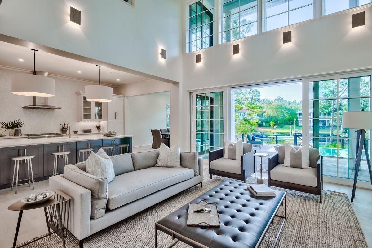 Beautiful naturalistic surroundings and prominent lake front positioning define this brand new construction designed by architect Tammy Massey and built by Arkon Group. This rare gem pairs architectural significance with stylish coastal aesthetics incorporating custom design elements and tranquil surroundings. Positioned on a quiet cul-de-sac on Eastern Lake, this home boasts over 3,300 square feet and yields four spacious bedroom suites and four and a half baths with an open living concept. 

Notable features of this layout include two master bedrooms each offering an ensuite bath (one on the first floor and a secondary master on the second floor), including spacious walk-in closets, floor to ceiling windows, vaulted ceilings and panoramic water views. High attention to detail is evident  with the thoughtfully curated interiors including the gourmet chef's kitchen which features a large oversized island, professional series Thermador appliances and quartz countertops as well as an ambient gas fireplace and designer touches with an exceptional furniture Package by James Design Company. 

This open floor plan was designed for indoor and outdoor living featuring thoughtful details which include two levels of outdoor living, a sizable resort style pool deck, outdoor shower, private boat dock and fire pit all situated overlooking one of 30a's spectacular coastal dune lakes. This central location positions the new owner for utmost privacy juxtaposed easy access to world class dining, boutique shopping and outstanding local entertainment all along Scenic Highway 30A.