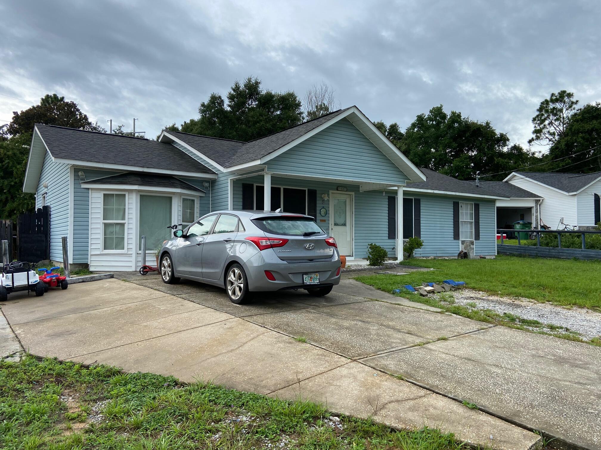 This 3 bedroom 2 bath home, plus an office, sits on an expansive lot and has a freshly painted interior. The office could serve as a 4th bedroom if needed. Very cute small cul du sac neighborhood and the house has a great floor plan! There is a combination pantry and laundry room off the kitchen. The office sports a large bay window. There are 3 outbuildings at the rear of the property, two with electricity.  One, used now as a ''man-cave'' and a separate shop and a storage shed. The back yard has plenty of room for a pool and there is a screened porch that looks out across the yard from the rear of the home. Plenty of parking in the expanded parking area at the front of the house for cars, boat or other toys! 
This home has tons of potential and is ready for you to add your personal touches