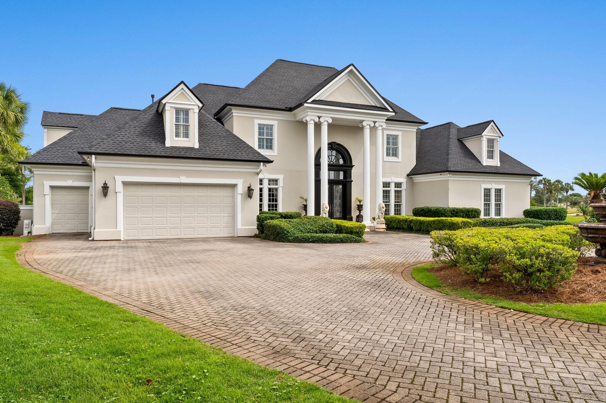 Nestled within the gates of the area's most desired neighborhood, this Legend Hills estate home is situated on a quiet Cul-de sac in the Fairways offering exceptional lakefront views while overlooking the renowned Bay Point Nicklaus Designed golf course. As you enter the front door, an architectural masterpiece awaits. This home provides over 5,500sf of living space and elegant finishes, including custom lighting, stone and hardwood floors, custom cabinetry, and a dramatic fireplace focal point. This is a bright and spacious home with high ceilings, custom crown molding and an abundance of natural light, is great for entertaining, with surround sound, built-in wine chiller, multiple indoor and outdoor dining areas, and a Chef Designed gourmet kitchen with high-end appliances, plus a full Butler's Pantry. Enjoy lake and Nicklaus course views along with amazing sunsets from your large pool deck. The first floor also includes a master wing, the master suite is elegantly designed and opulently appointed with generous square footage, incredible views through oversized windows, a separate sitting area, a luxurious ensuite, double boutique-style closets, as well as an additional bedroom. Three more bedrooms are located upstairs, along with a private office and without a doubt one of the most amazing playrooms that will delight all the kids regardless of age!
The oversized climate controlled two-car garage features built-in storage and cabinetry and has a separate golf cart garage. It is perfect for all your adult toys! Just minutes from your door is the completely renovated Bay Point Marina. This full-service Marina is literally just minutes to the pass and can accommodate boats up to 130 feet! The Marina's proximity to the Gulf of Mexico and the Intracoastal Waterway make it a true paradise for boaters and fisherman and all those attracted to an elevated lifestyle on the water. All ages, SF and sizes are approximate.