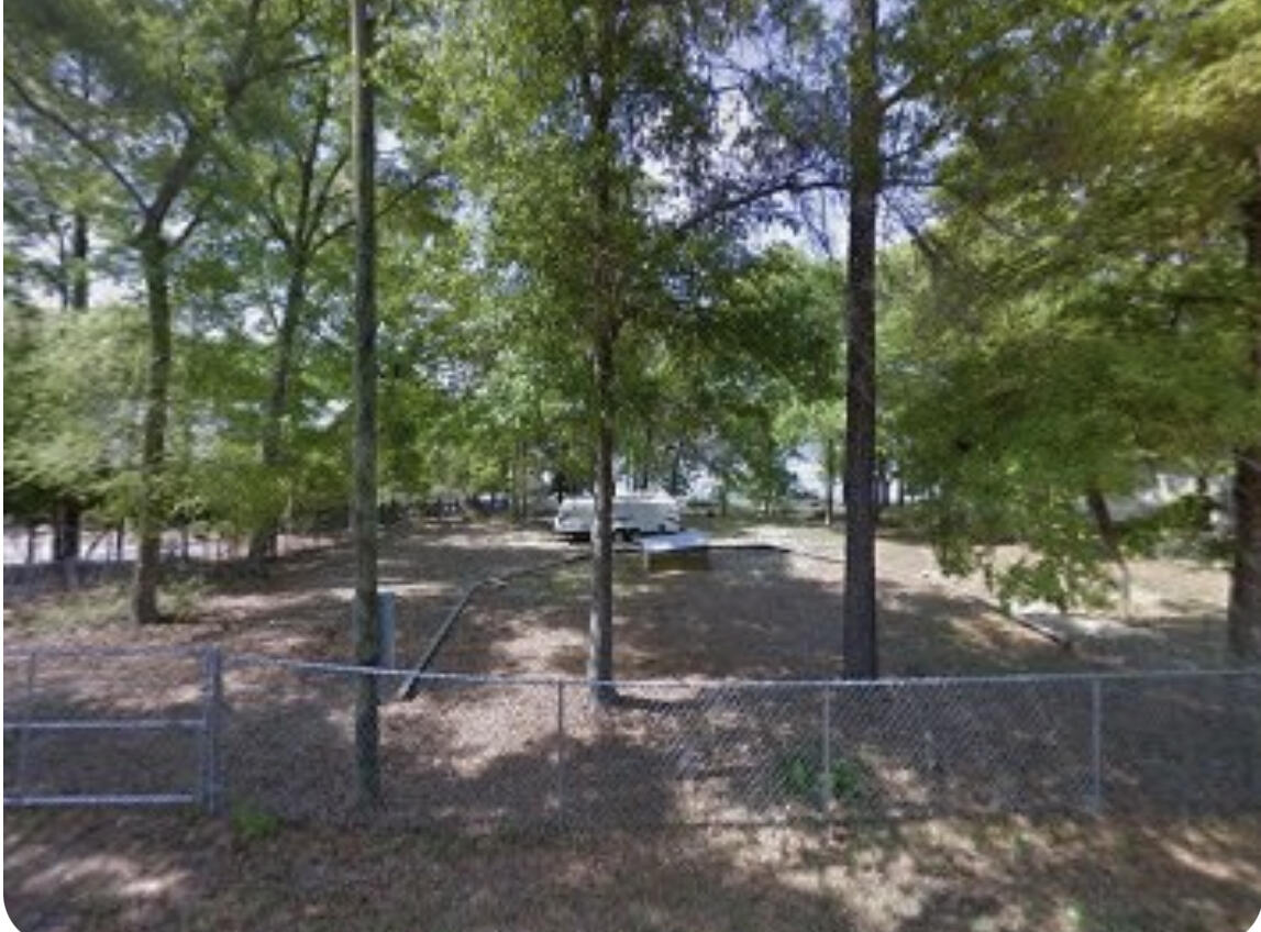 Don't miss this one! Bring your RV and friends to camp and enjoy this little slice of Paradise! Endless possibilities to create your own fish camp or country retreat!. Lot slopes to Juniper Lake. Lake contains Bass, Crappie, and catfish.  Fish from your dock or take your boat out to the center and enjoy the serenity of it all.  Quiet and peaceful environment to bird watch or feed the turtles from your dock.
