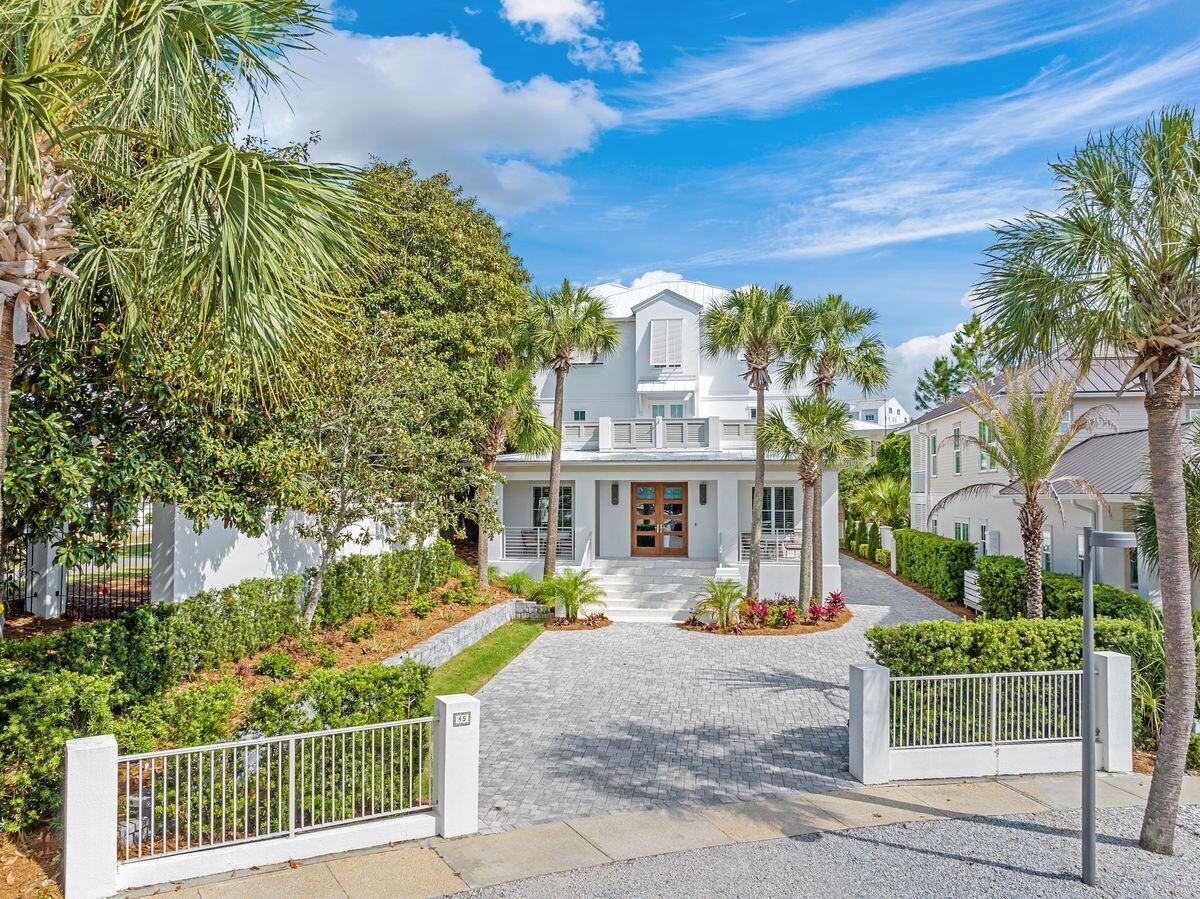 Set behind the gates of the exclusive Village of White Cliffs, this stunningly reimagined residence blends timeless coastal design with elevated elegance, just moments from the sugar-white sands of Blue Mountain Beach. Completely remodeled in 2020 and meticulously maintained since, this 5-bedroom, 5 full bath, 2 half bath, plus office retreat offers over 4,200 square feet of refined living space and gulf views from its top-floor, covered veranda.

The home makes a statement from the moment you arrive—clean-lined white stucco, professional landscaping, and a gracious front entry framed by swaying palms. Inside, wide-plank hardwood floors, custom millwork, and a palette of soft neutrals provide an atmosphere of understated luxury. The vaulted great room impresses with its beamed wood ceilings and dual iron chandeliers, anchored by Restoration Hardware furnishings that convey with the home.

The designer kitchen offers style and substance with custom cabinetry, sleek appliances, quartz countertops with waterfall edges, and a spacious island perfect for entertaining. A butler's pantry with wine cooler, ice maker and custom cabinetry adds both function and flair.

Each bedroom is a sanctuary, featuring en suite baths with spa-like finishes, generous closet space, and designer lighting. The home features two true primary suites, each offering its own distinctive character and comfort. The first suite boasts a serene sitting area, expansive custom-built closet, and a spa-like bath with freestanding soaking tub, oversized glass shower, and twin vanities. A second primary suite dazzles with chevron-accent feature wall, designer lighting, and a bath featuring upscale decor.

The home also features a built-in bunk room, a separate dedicated office, two laundry areas, and a drop-zone style mudroom with custom storage built-ins. Tech-savvy upgrades include motorized window shades, surround sound, and elevator access to all levels. Even the garage has been outfitted with cabinets and extra storage.

Outdoor living is just as exceptional. The covered summer kitchen is equipped with built-in grill, vent hood, sink, and prep space, while the adjacent fireplace lounge with TV connection invites year-round enjoyment. The third-story covered veranda captures breezes and gulf viewsideal for morning coffee or golden-hour gatherings.

Additional highlights:
"	Oversized two-car garage with extended paver driveway
"	Exquisite trim detail
"	Offered fully furnished with Restoration Hardware pieces
"	Non-short-term rental community with deeded beach access, resort-style community pool, and tennis court
"	Gated entry in the heart of Blue Mountain Beach

All within walking distance to favorites like Red Fish Taco, Blue Mountain Creamery, Basmati's, Mimmo's and so much more.

A rare offering in one of 30A's most sought-after enclaveswhere design meets livability, and every detail is polished to perfection.