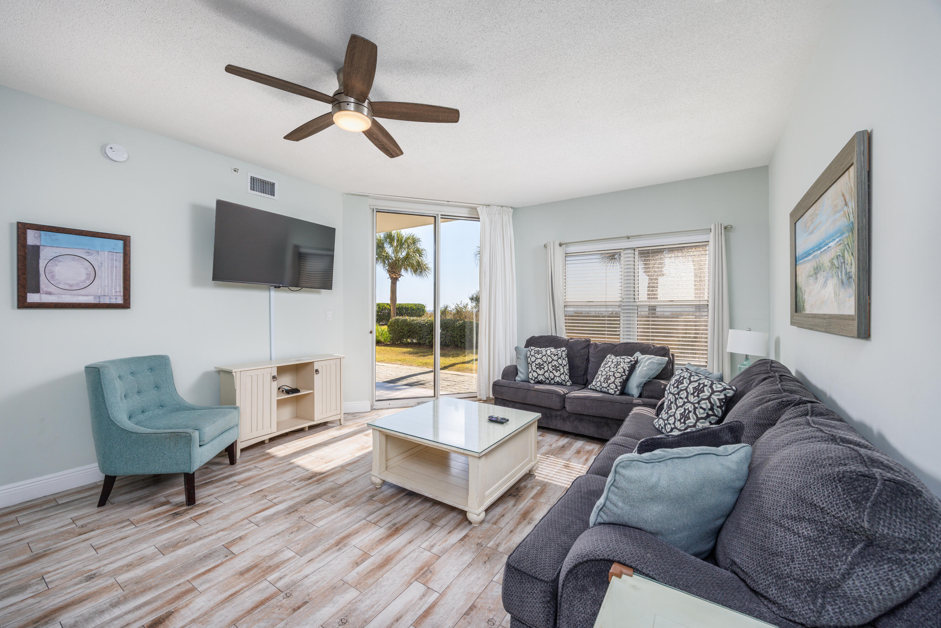 Waters Edge #104 offers a well-positioned opportunity to own a ground-floor, fully furnished beachfront condo on Okaloosa Island, conveniently located near the resort pool and barbecue grilling area. This updated 3-bedroom plus bunk, 3-bath residence features an open layout designed for comfort, durability, and broad guest appeal. The living area opens to a ground-level patio with easy access to landscaped grounds and a short, path to the pool, grills, and beach.  Sold rental ready, the unit supports immediate use within an established short-term rental program. Waters Edge provides gulf-front amenities including pools, grilling areas, and covered parking, with convenient proximity to the Okaloosa Island Pier, dining, and Destin.