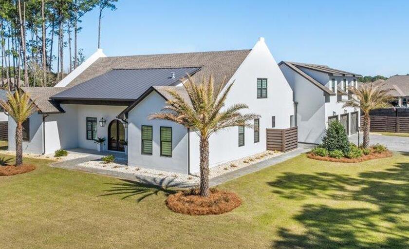 A stunning 7 Bedroom, 5.5 Bath Estate, Perfectly situated on  3/4 acres across from the Bay, complete with resort-style pool, outside kitchen, and a beautifully designed carriage house! Upon entering you'll discover a spacious and functional  floor plan with an expansive living area great for entertaining and everyday living.  The kitchen boast a large island, top of  line appliances with Z-Line Gas stove and Z-Line Convection/Microwave Oven, Bosh Dishwasher perfect for the culinary enthusiasts! The 1st floor Master Suite offers ultimate comfort with his and her closets and spa-like en-suite bath. Also on the main level are two additional bedrooms with Jack and Jill bath. Upstairs you'll find two bedrooms with 2 baths along with an entertainment room, perfect for a lounge, Children's play room, or home theater. An additional storage room provides extra space.  The detached carriage house adds even more value, offering a full kitchen, washer/dryer, and private living quarters. Perfect for guest or extended family.  Don't miss the opportunity to own a stunning property in a prime location.