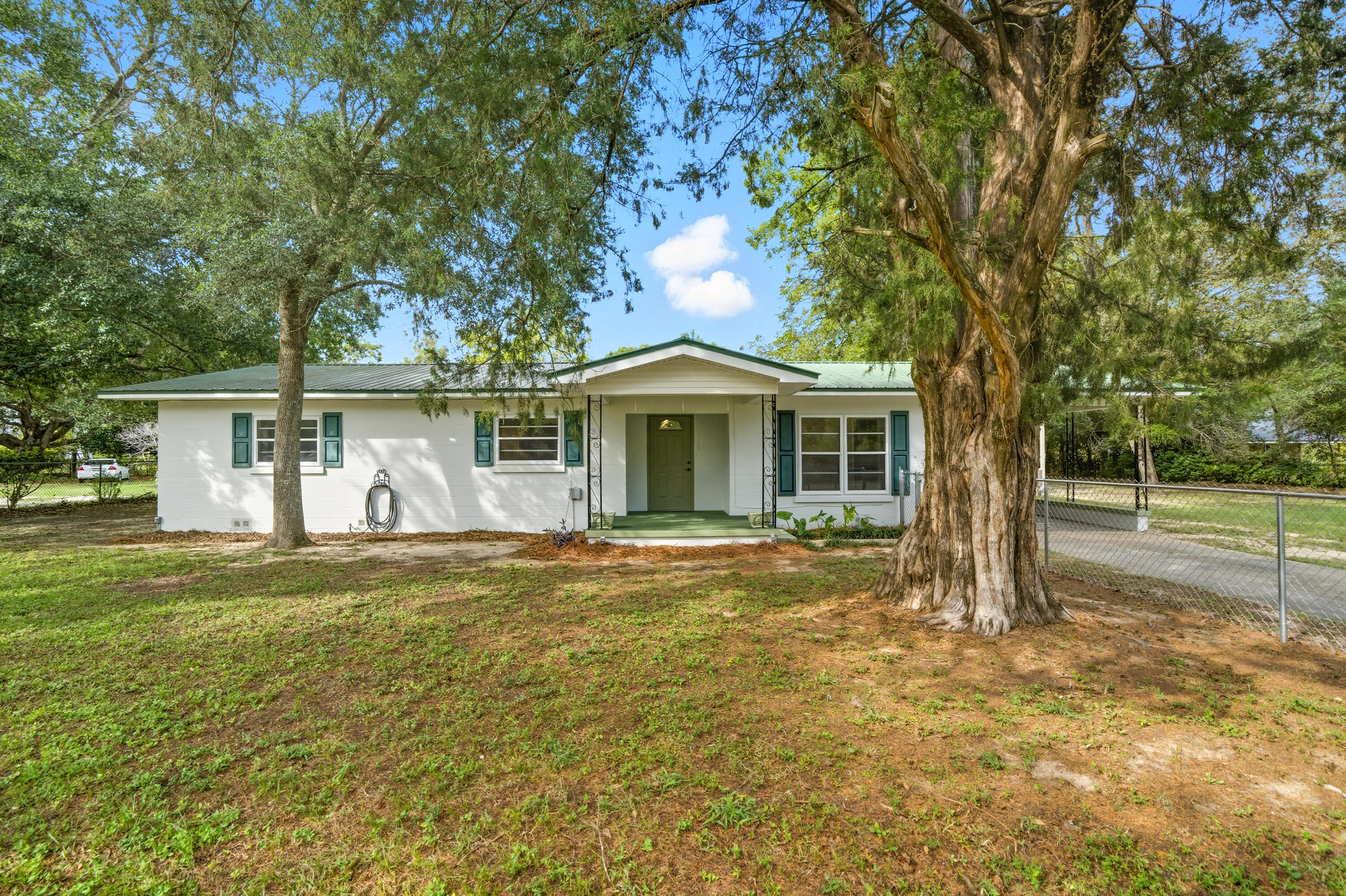 Built in 1960, this well-maintained 4-bedroom, 2-bath home offers approximately 1,548 square feet of living space and a total of 1990 sqft under roof space on a full acre with no HOA. The home features updated laminate wood flooring throughout, a refreshed interior and exterior paint, and a beautifully updated kitchen with repainted cabinets and new granite countertops. The laundry area includes a convenient sink, toilet, and shower.

Recent upgrades include a 2022 HVAC system, PEX plumbing, a new breaker box, and a durable metal roof. The septic system and drain field were replaced in 2017, providing peace of mind for years to come. Outside, you'll find a 1,253 square foot metal barn, perfect for storage, workshop use, or recreational space. The property also includes a custom-built gazebo on a concrete slab, mature fruit trees, and both chain-link and field fencing that surround portions of the acre. Survey available.
This solid, thoughtfully updated home provides both comfort and functionalityready for its next owner to enjoy.
Room measurements not available; buyer to verify all dimensions and square footage if important.