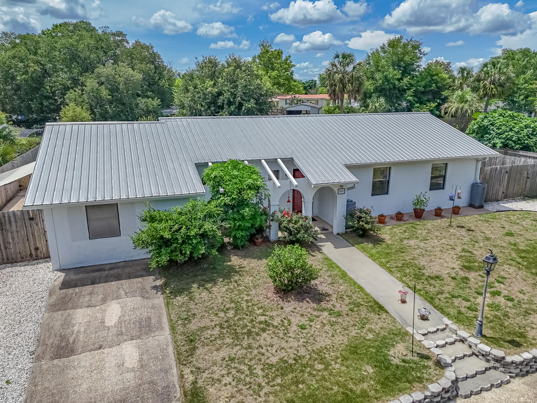 CURRENTLY UNDER CONTRACT, SELLER WILL CONSIDER BACKUP OFFERS Welcome to 3892 Belmar Place! Seller has 160k FHA assumable mortgage at 3%. Nestled in the heart of Sunny Hills, this charming 3-bedroom, 2-bath (Jack and Jill style) home is perfectly located for both relaxation and convenience. Just a stone's throw from Boat Lake and only minutes from the golf course, this home offers a tranquil retreat with easy access to all the amenities you need. Sunny Hills is ideally situated just 12 miles south of Interstate 10. A short 15-minute drive takes you to Chipley for daily shopping, while a scenic 25-mile journey leads to the vibrant Panama City and its stunning Gulf beaches. This perfect positioning allows you to enjoy small-town serenity while staying close to urban centers and beachside fun. Inside, the home features new LVP flooring and a cozy Florida room, perfect for relaxing or entertaining. The property includes an updated metal roof, a backup generator, and a privacy-fenced backyard with a spacious covered patio. Additionally, the gutters connect to rain barrels, allowing you to capture and reuse rainwater. There's also an 8x10 outdoor storage area to accommodate all your outdoor essentials along with additional storage attached to the house. The current owner is moving out, so this home is ready for you to move in and make it your own. Don't miss out on this must-see propertyschedule your showing today and discover all that Sunny Hills living has to offer!