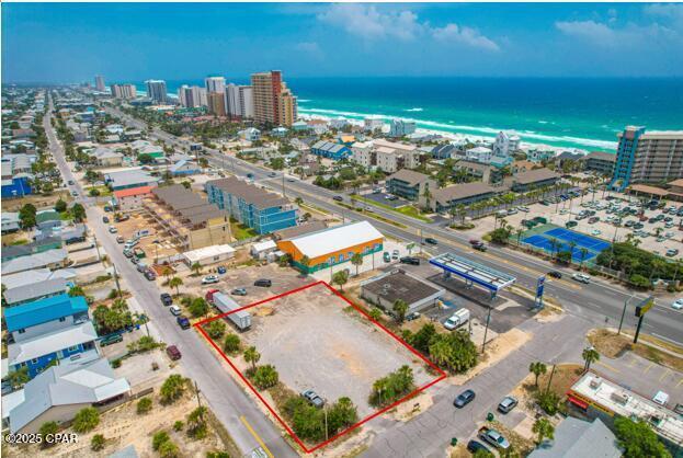 Three 50' x 115' lots totaling 0.4 Acres. located at the southeast corner of Upas Street and Beach Drive.----Prime residential and/or Commercial Development Opportunity. Investors, Builders & Entrepreneurs take notice! 🏖️ An exceptional opportunity awaits on Beach Drive in Panama City Beach, just 900 feet from the Gulf of America! The attached site plan includes five +/-1,800 sq. ft. townhomes. Location: Short walk to the Beach, surrounded by new construction homes, high-rise condos, restaurants, public beach access, and major attractions Not in a flood zone - despite being only steps from the beach! Excellent for commercial, mixed-use, or multifamily development. Zoning & Development Details: Zoning: C-1 Neighborhood Commercial within unincorporated Bay County. Density: Up to 15 units per acre. Max Building Height: 35 feet. Impervious Surface Ratio: 60%. Floor Area Ratio: 100% Setbacks: 20 ft. front/rear, 5 ft sides. The adjacent Sunny Side Beach Store is also for sale