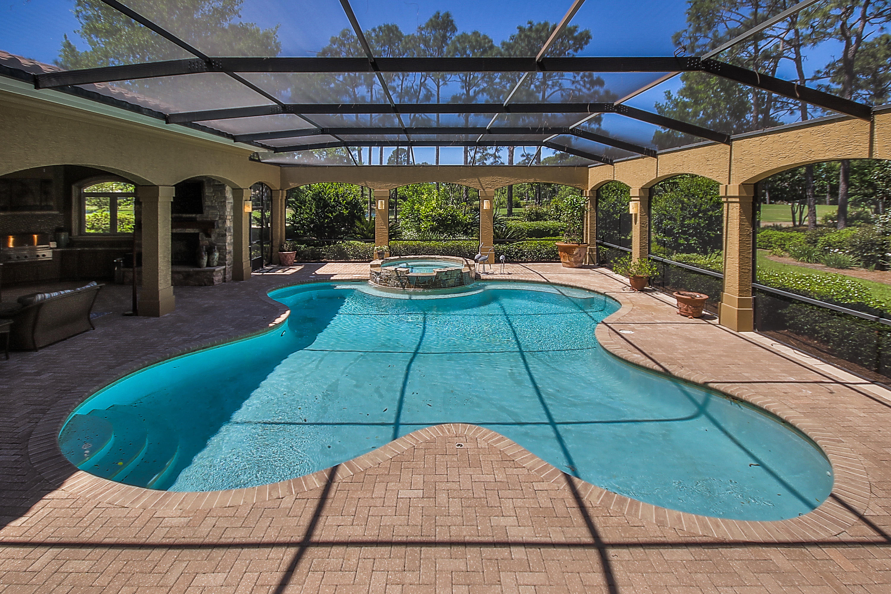 PRICE REDUCE $200,000 ''TODAY'' GREAT BUY $285/FOOT::: This Elegant Custom Master Home features 5 spacious bedrooms and 5 baths. A warm and inviting 2 story foyer greets you with views of the screened-in pool, lake and golf course. The Grande Salon is punctuated by soaring ceilings, impressive fireplace, walk in bar and a wall of glass windows and doors which provide for expansive pool and golf course views. The Kitchen and Family Room have walls made of a unique French limestone application, which is also used to help maintain a proper temperature in the wine cellar nestled beneath the curved, entry stairway. The kitchen features custom cabinetry, granite countertops, top of the line appliances, Kitchen Island with a breakfast bar and a creamy granite top, tile backsplash, woo floors and recessed lighting. The breakfast nook is right off the kitchen and has wonderful views of the ''Outdoor Summer Kitchen'', pool, and golf course. Next to the breakfast nook is the large family room with a built in media center, hidden wet bar, fireplace with floor to ceiling stone, exposed beams and access to the outdoor living space and pool. The Master Bedroom boasts beautiful Brazilian cherry floors, Venetian plaster walls, stately stone fireplace, sitting area, access to the screened in pool, large master walk-in closet and crown molding. Jerusalem Stone covers the Master Bathroom floors and shower walls. Master bathroom also features his and her vanities, free standing claw foot tub and spa-like shower. The second floor has 3 bedroom suites and a fourth bedroom/bonus room which can be accessed by two separate stairways. Just outside is a very spacious outdoor living area and summer kitchen. The Summer Kitchen has granite countertops, sink, plenty of cabinet space and top of the line Viking grill,Ice machine and Refrigerator... This smart home is complete with Lutron Electronics home lighting control with the ability to control the lighting of your home and heating of the pool from any location with your laptop. Schedule your private showing today.